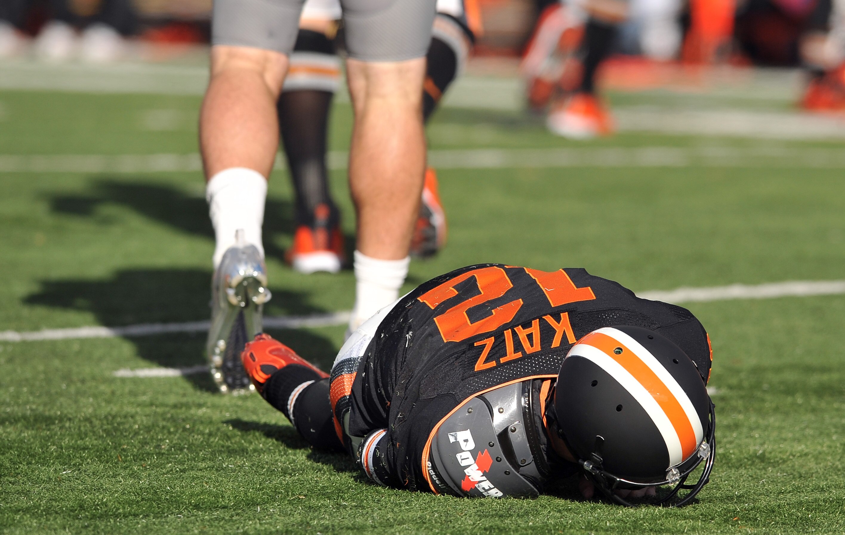 CORVALLIS, OR - DECEMBER 4: Quarterback Ryan Katz #12 of the Oregon State Beavers lays on the turf after being hit by Casey Matthews #55 of the Oregon Ducks in the first quarter of the game at Reser Stadium on December 4, 2010 in Corvallis, Oregon. The Du
