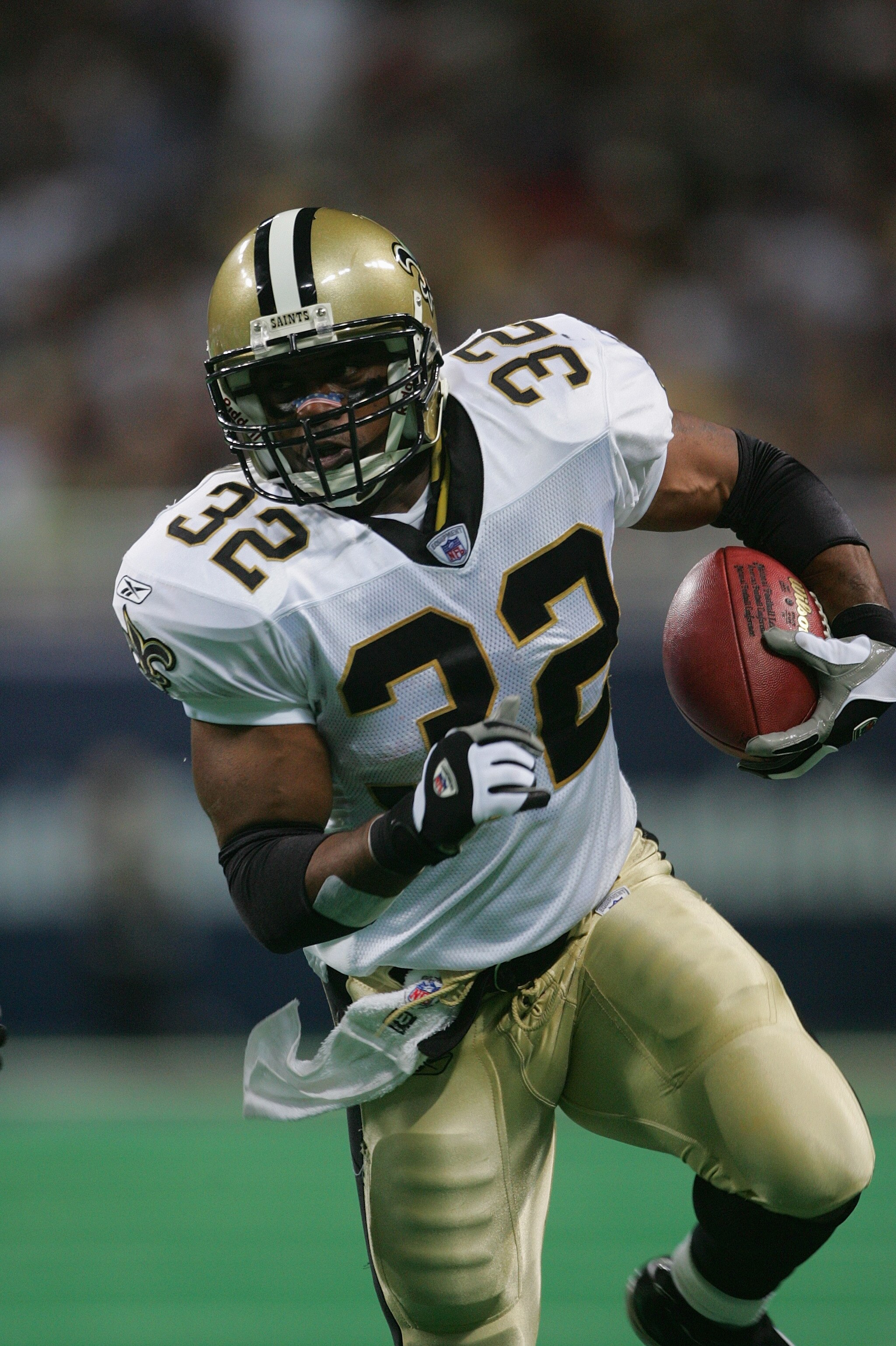 ST. LOUIS - SEPTEMBER 26:  Running back Ki-Jana Carter #32 of the New Orleans Saints carries the ball against the St. Louis Rams during the game at the Edward Jones Dome on September 26, 2004 in St. Louis, Missouri. Saints defeated the Rams 28-25 in overt