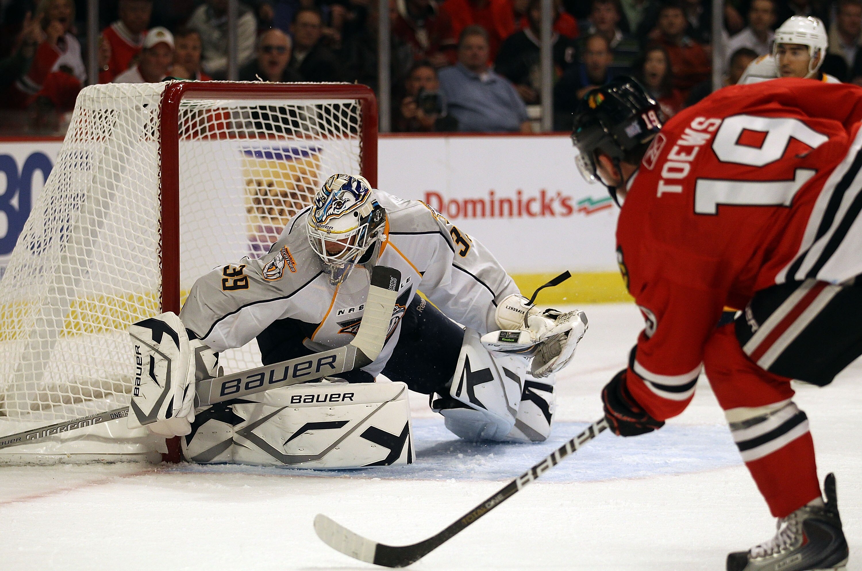 CHICAGO - OCTOBER 13: Jonathan Toews #19 of the Chicago Blackhawks scores a goal in the 1st period against Anders Lindback #39 of the Nashville Predators at the United Center on October 13, 2010 in Chicago, Illinois. (Photo by Jonathan Daniel/Getty Images