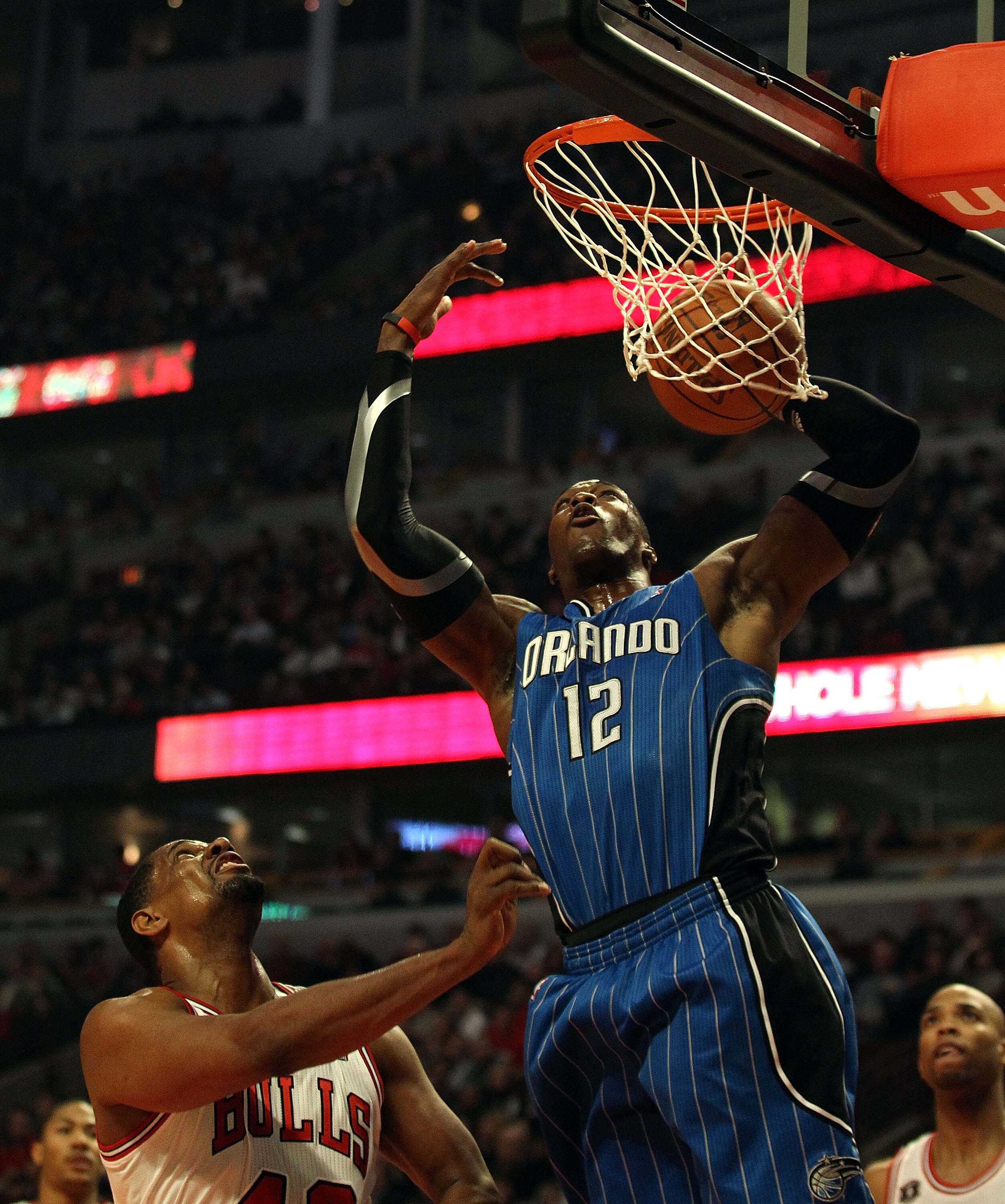CHICAGO, IL - JANUARY 28: Dwight Howard #12 of the Orlando Magic dunks the ball over Kurt Thomas #40 of the Chicago Bulls at the United Center on January 28, 2011 in Chicago, Illinois. NOTE TO USER: User expressly acknowledges and agrees that, by download