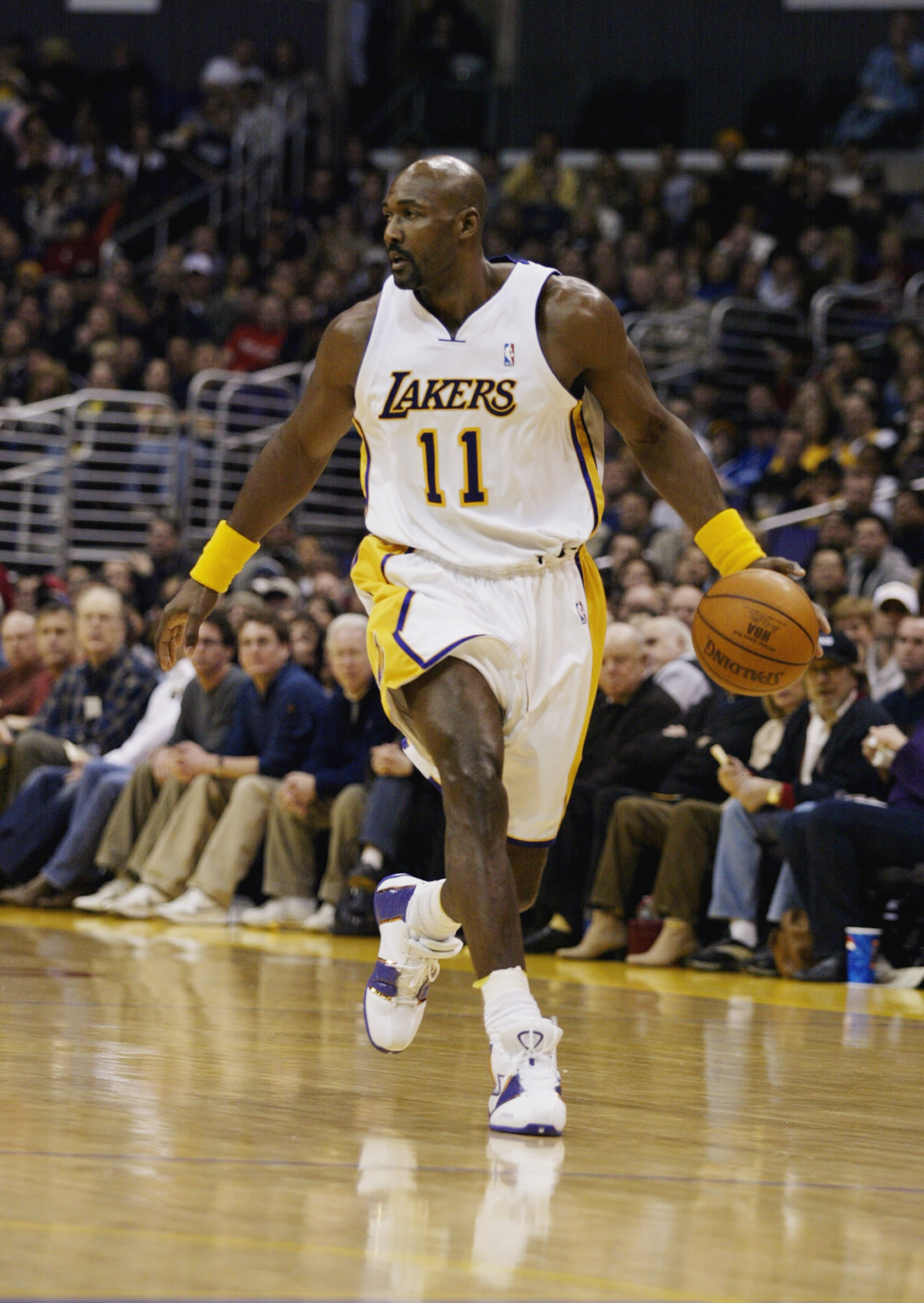 LOS ANGELES - DECEMBER 21:  Karl Malone #11 of the Los Angeles Lakers moves the ball during the game against the Phoenix Suns on December 21, 2003 at Staples Center in Los Angeles, California.  The Lakers won 107-101.  NOTE TO USER: User expressly acknowl