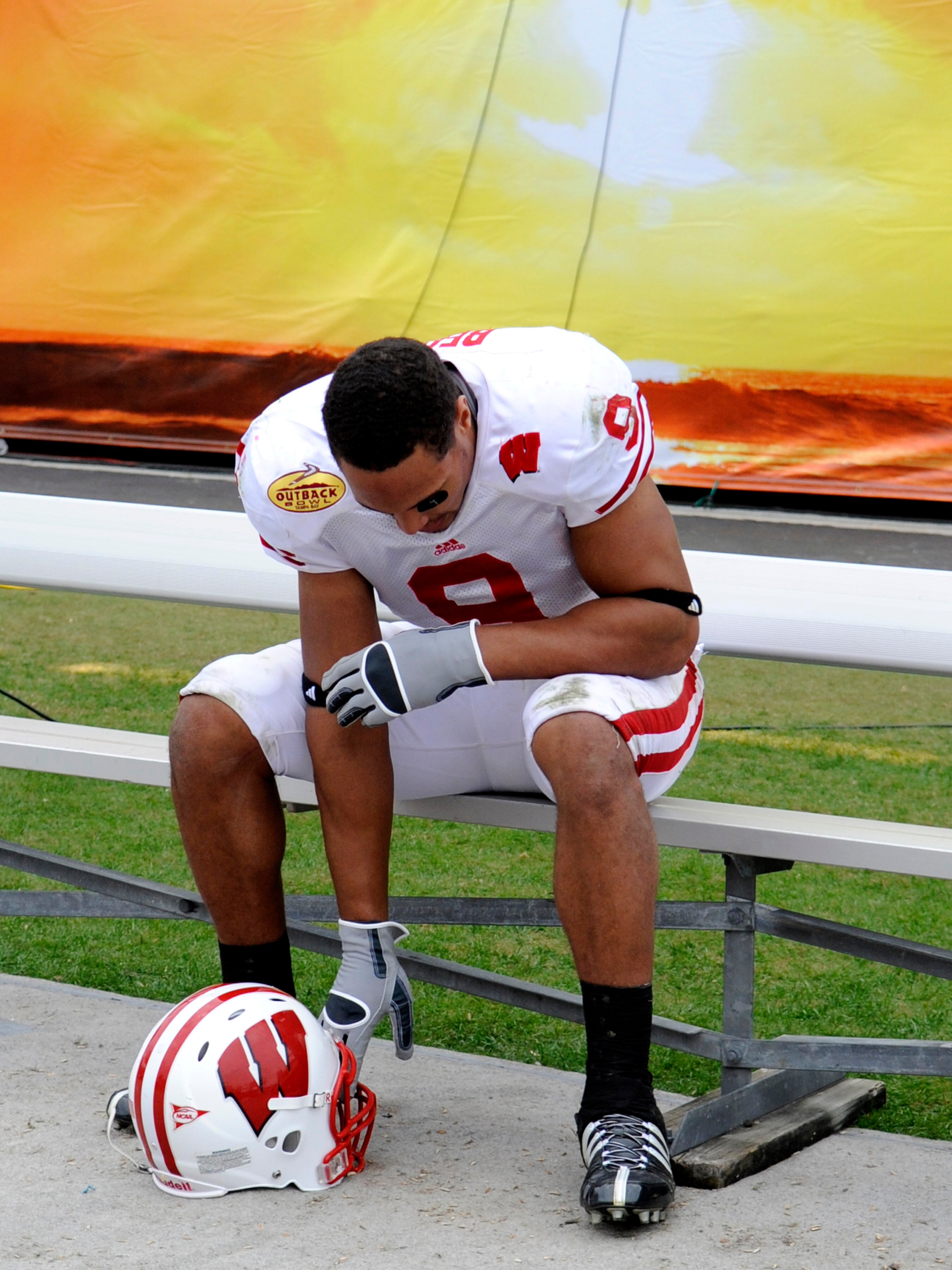 TAMPA, FL -  JANUARY 1: Tight end Travis Beckum #9 of the Wisconsin Badgers sits alone on the bench after a loss to the Tennessee Volunteers in the 2008 Outback Bowl at Raymond James Stadium on January 1, 2008 in Tampa, Florida.  The Volunteers won 21 - 1