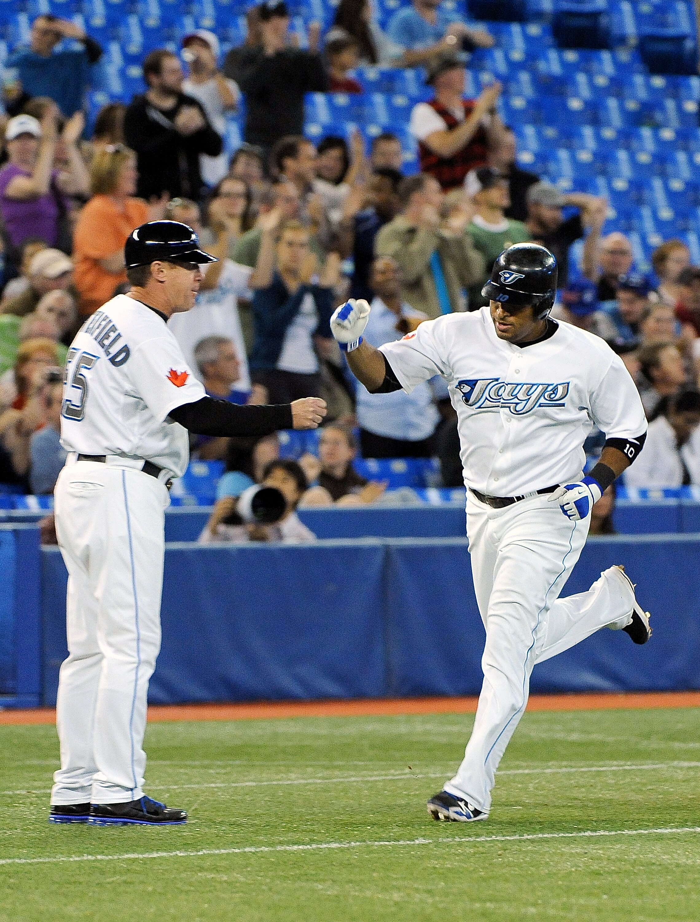 TORONTO, ON - SEPTEMBER 22:  Vernon Wells #10 of the Toronto Blue Jays passes by third base coach Brian Butterfield after his homerun against the Seattle Mariners on September 22, 2010 at the Rogers Centre in Toronto, Canada.  (Photo by Matthew Manor/Gett