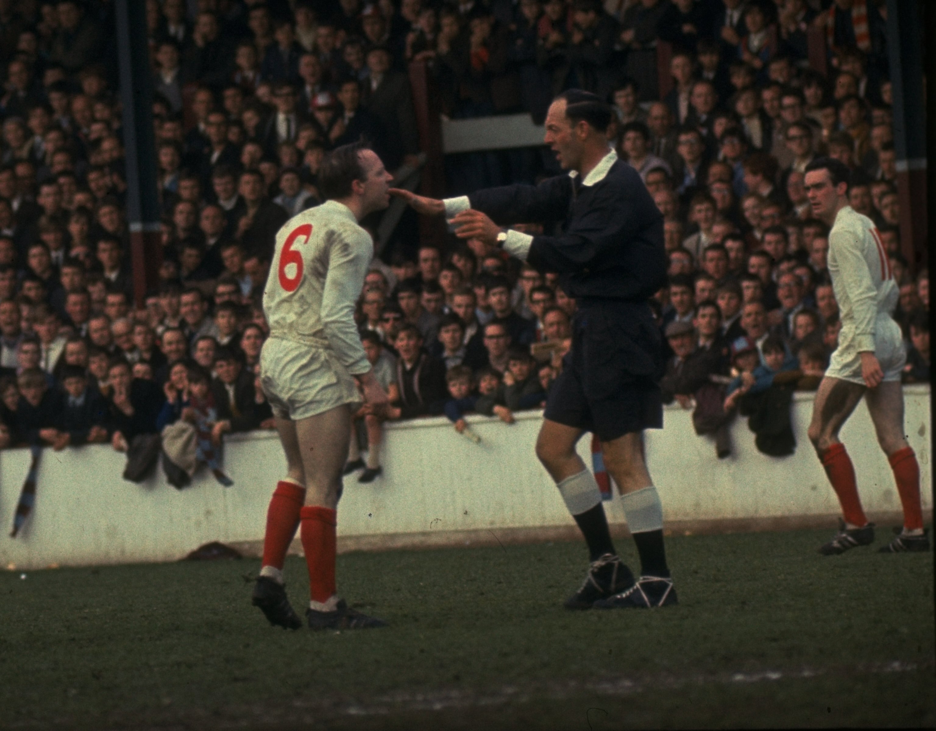 1960:  Nobby Styles #6 of Manchester United has a disagreement with the referee (second right) during a match against West Ham. \ Mandatory Credit: Alllsport UK /Allsport