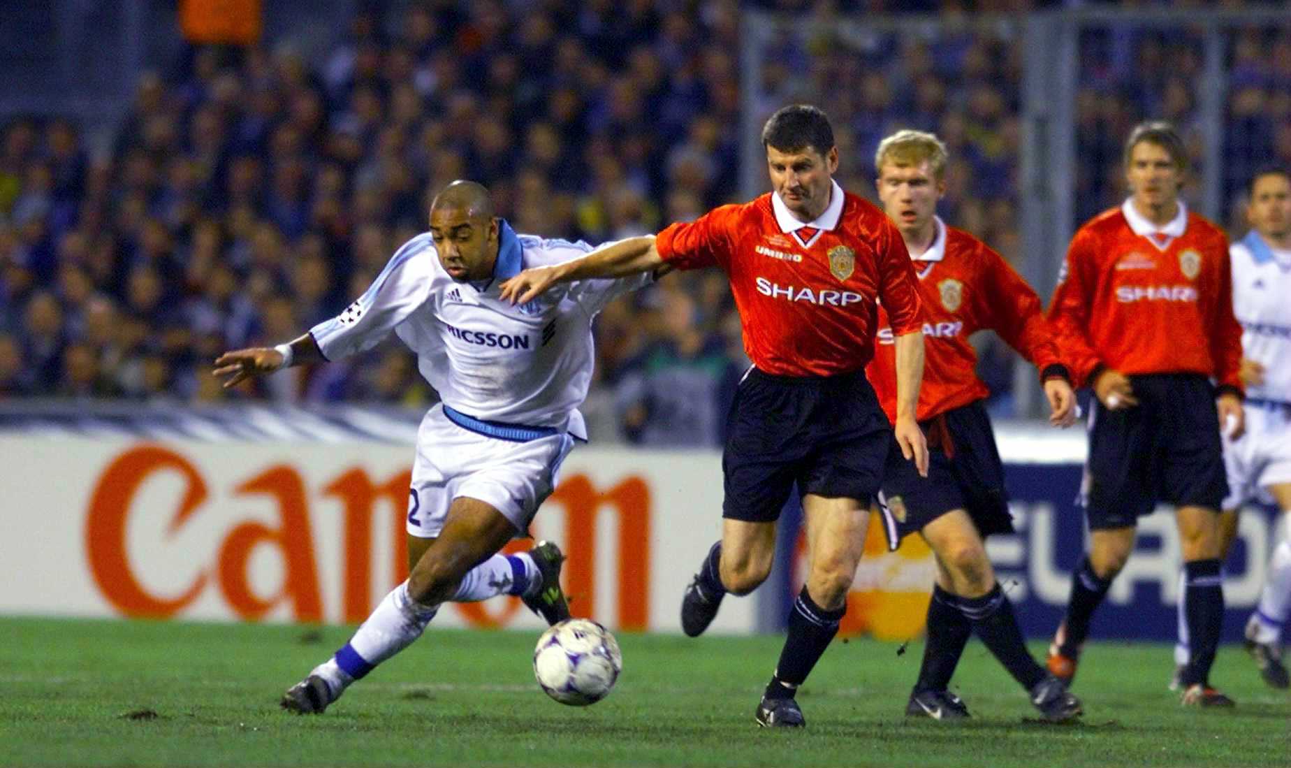 19 Oct 1999;  Denis Irwin of Man Utd holds off Stephane Dalmat of Marseille during the Olympique de Marseille v Manchester United UEFA Champions League, Group D match at the Stade Velodrome in Marseille, France. Mandatory Credit: Ross Kinnaird/ALLSPORT