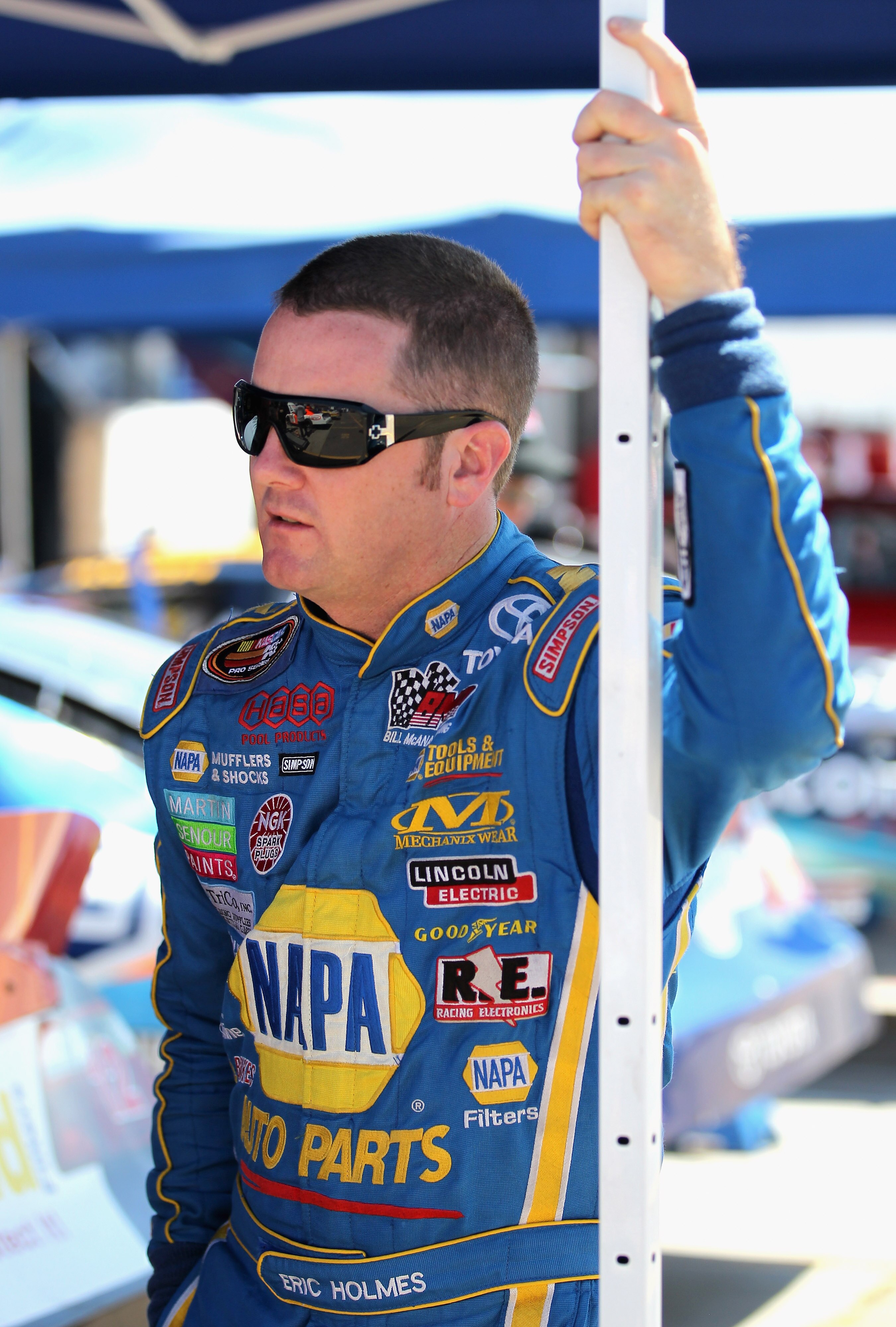 DACONO, CO - AUGUST 14:  Eric Holmes driver of the #20 NAPA Toyota looks on in the garage area during practice for the Toyota/NAPA Auto Parts Bonus Challenge 150 Race of the NASCAR K&N Pro Series West at the Colorado National Speedway on August 14, 2010 i