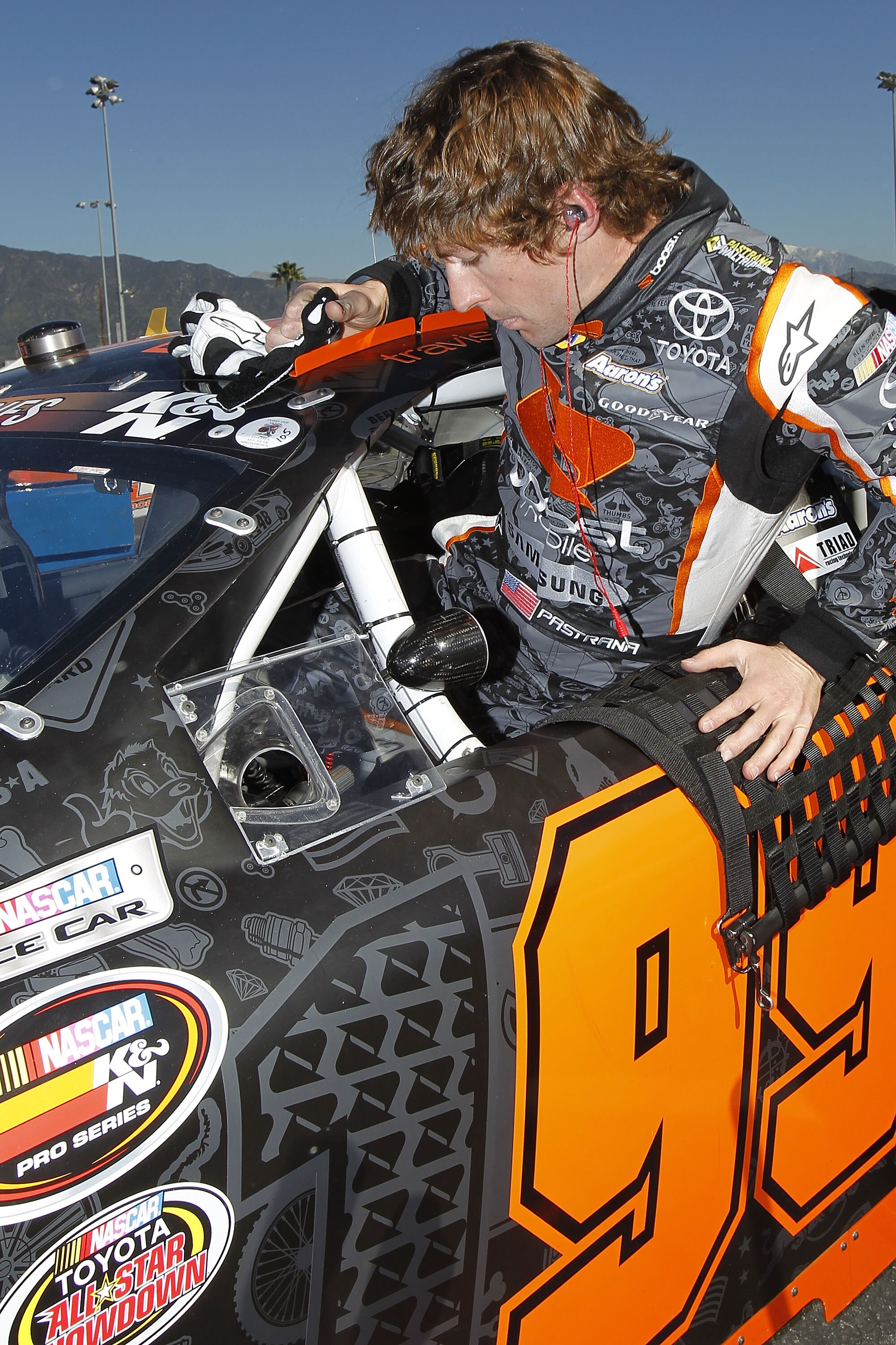 IRWINDALE, CA - JANUARY 28:  Travis Pastrana, driver of the #99 Boost Mobile Toyota, prepares to drive during practice for the NASCAR Toyota All-Star Showdown at Toyota Speedway at Irwindale on January 28, 2011 in Irwindale, California.  (Photo by Todd Wa