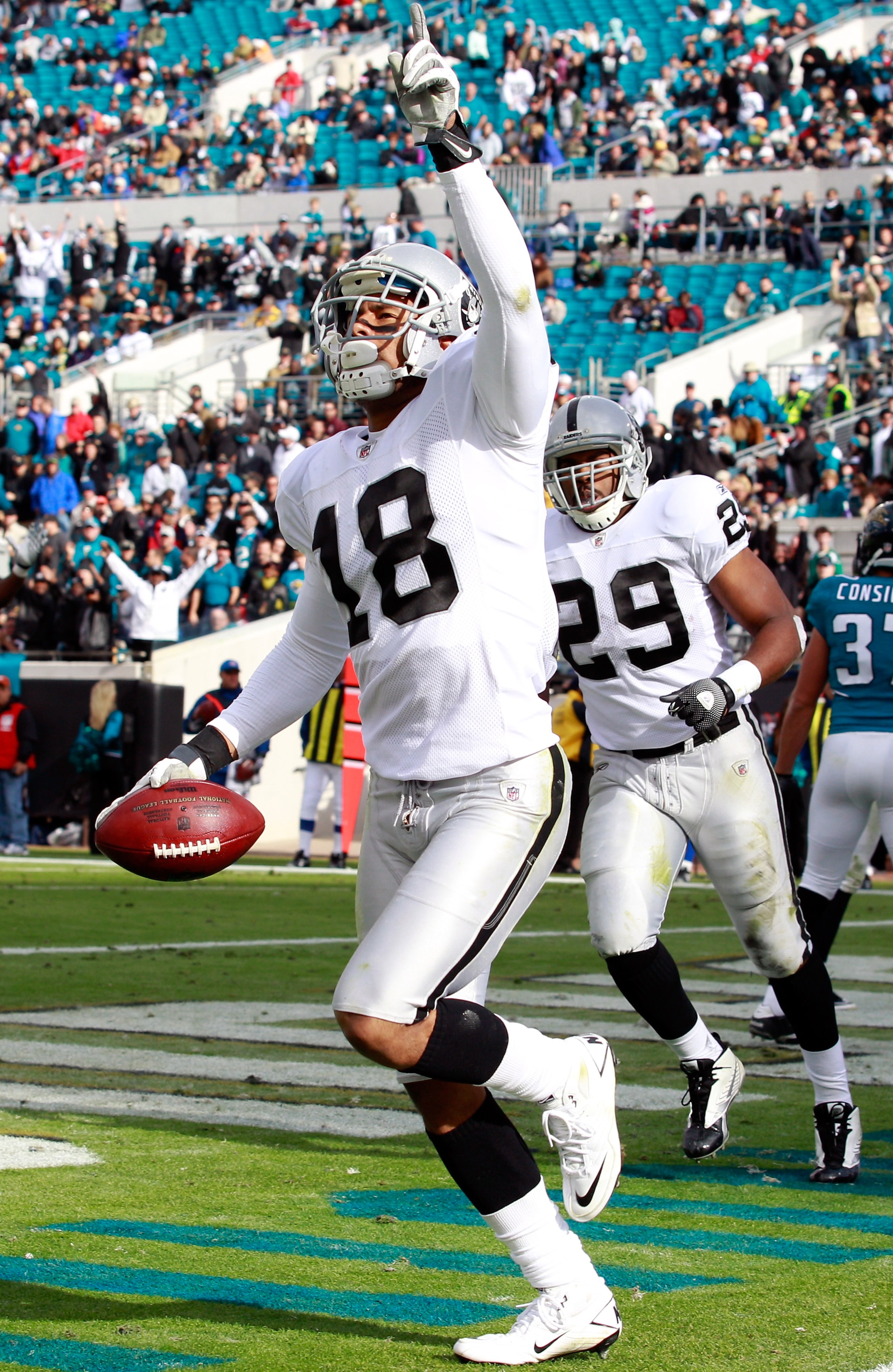 JACKSONVILLE, FL - DECEMBER 12:  Louis Murphy #18 of the Oakland Raiders celebrates a touchdown during the game against the Jacksonville Jaguars at EverBank Field on December 12, 2010 in Jacksonville, Florida.  (Photo by Sam Greenwood/Getty Images)