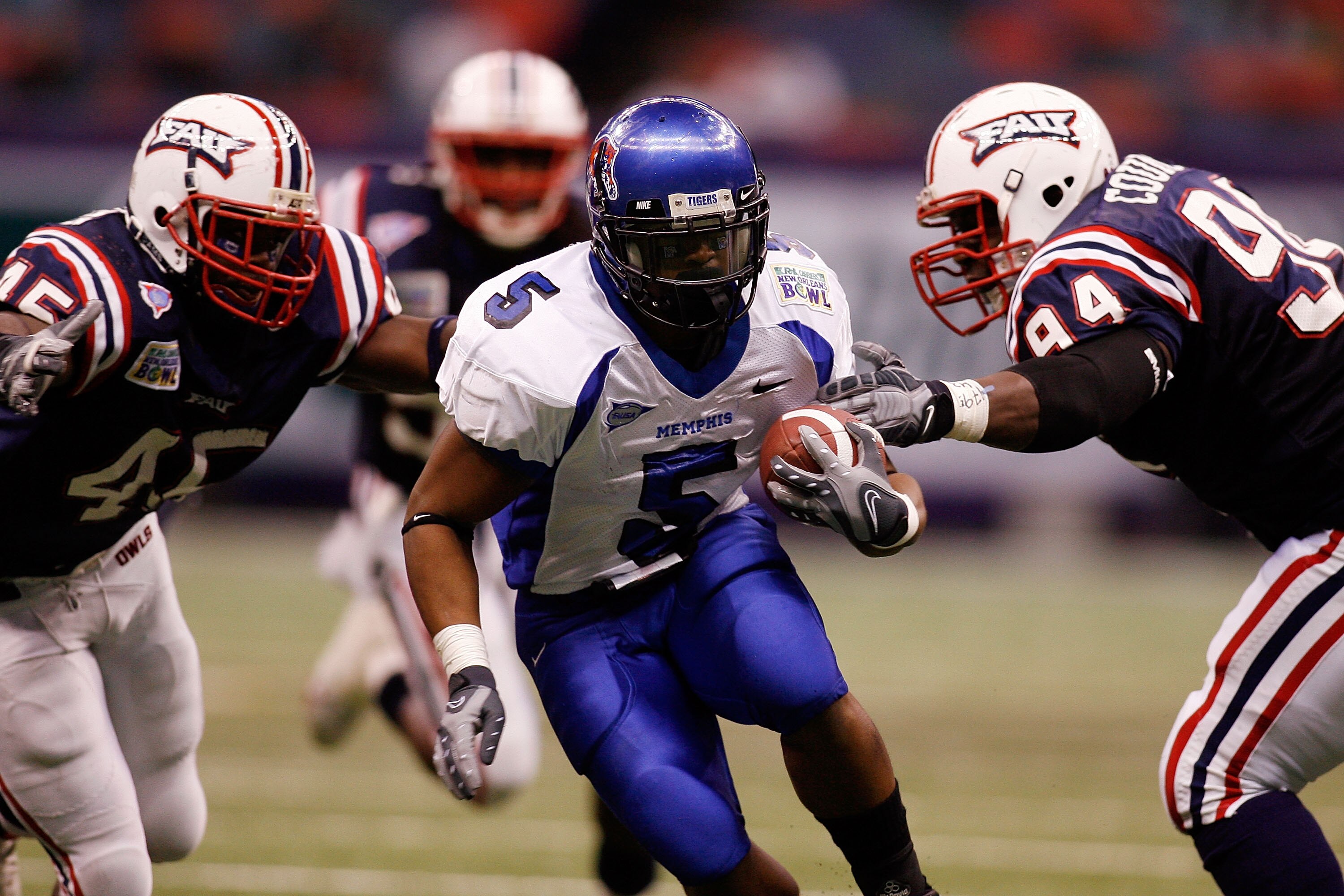 NEW ORLEANS - DECEMBER 21: Joseph Doss #5 of the Memphis University Tigers is tackled by Michael Hancock #54 and Jermaine Council #94 of the Florida Atlantic University Owls in the R+L Carriers New Orleans Bowl on December 21, 2007 at the Louisiana Superd