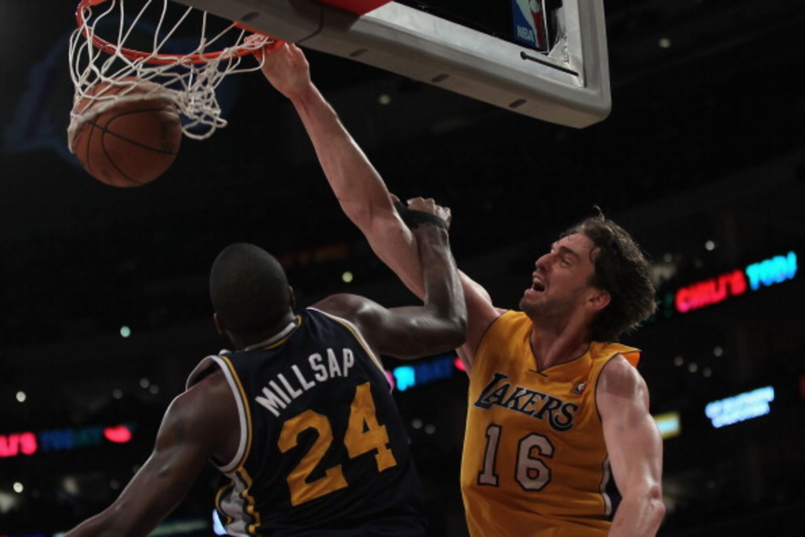 LOS ANGELES, CA - JANUARY 25: Pau Gasol #16 of the Los Angeles Lakers dunks over Paul Millsap #24 of the Utah Jazz in the second half at Staples Center on January 25, 2011 in Los Angeles, California. The Lakers defeated the Jazz 120-91. NOTE TO USER: Use LOS ANGELES, CA - JANUARY 25: Pau Gasol #16 of the Los Angeles Lakers dunks over Paul Millsap #24 of the Utah Jazz in the second half at Staples Center on January 25, 2011 in Los Angeles, California. The Lakers defeated the Jazz 120-91. NOTE TO USER: Use