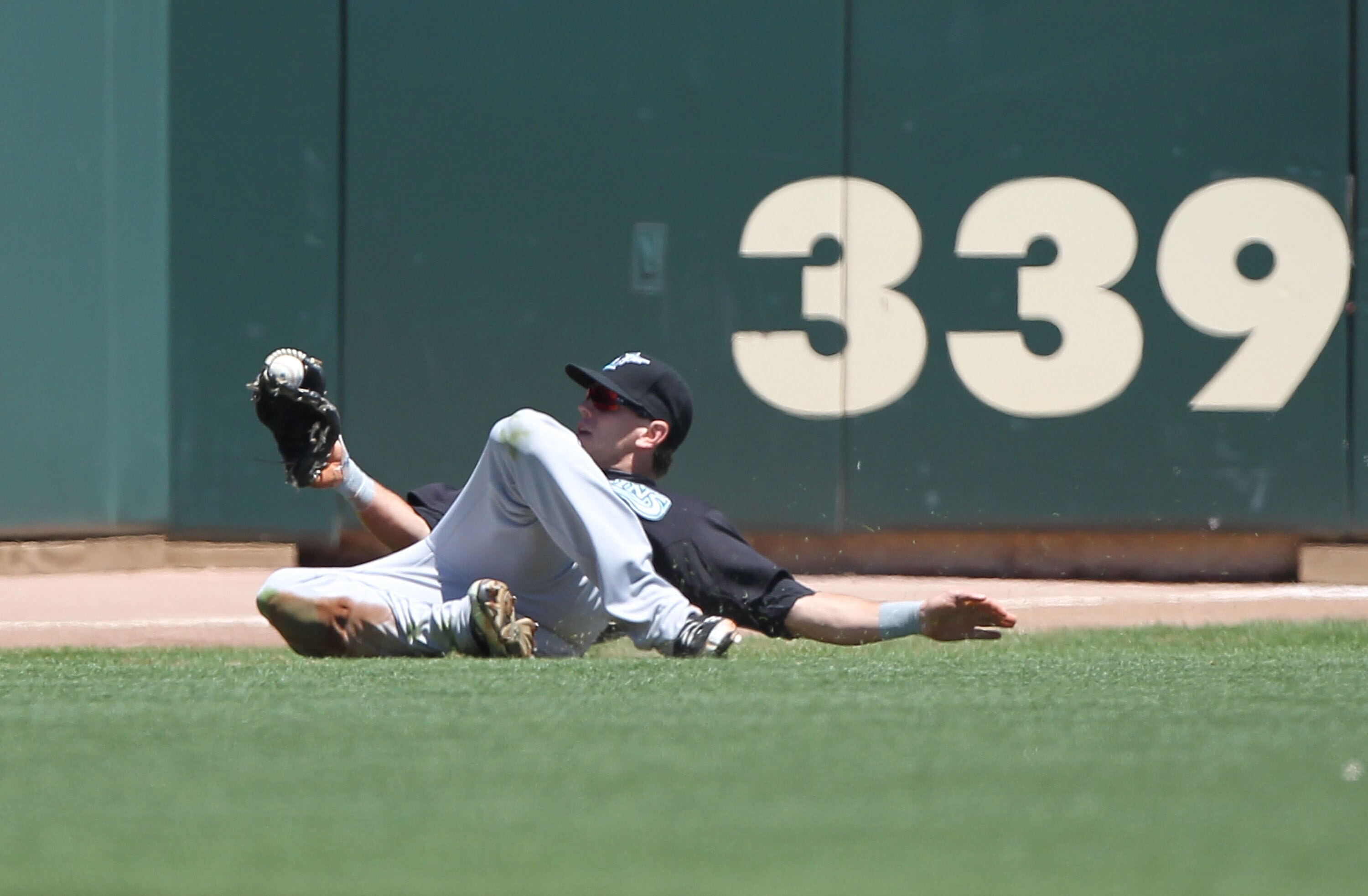 SAN FRANCISCO - JULY 29:  Logan Morrison #20 of the Florida Marlins catches a ball hit by Aubrey Huff #17 of the San Francisco Giants in the first inning during an MLB game at AT&T Park on July 29, 2010 in San Francisco, California.  (Photo by Jed Jacobso