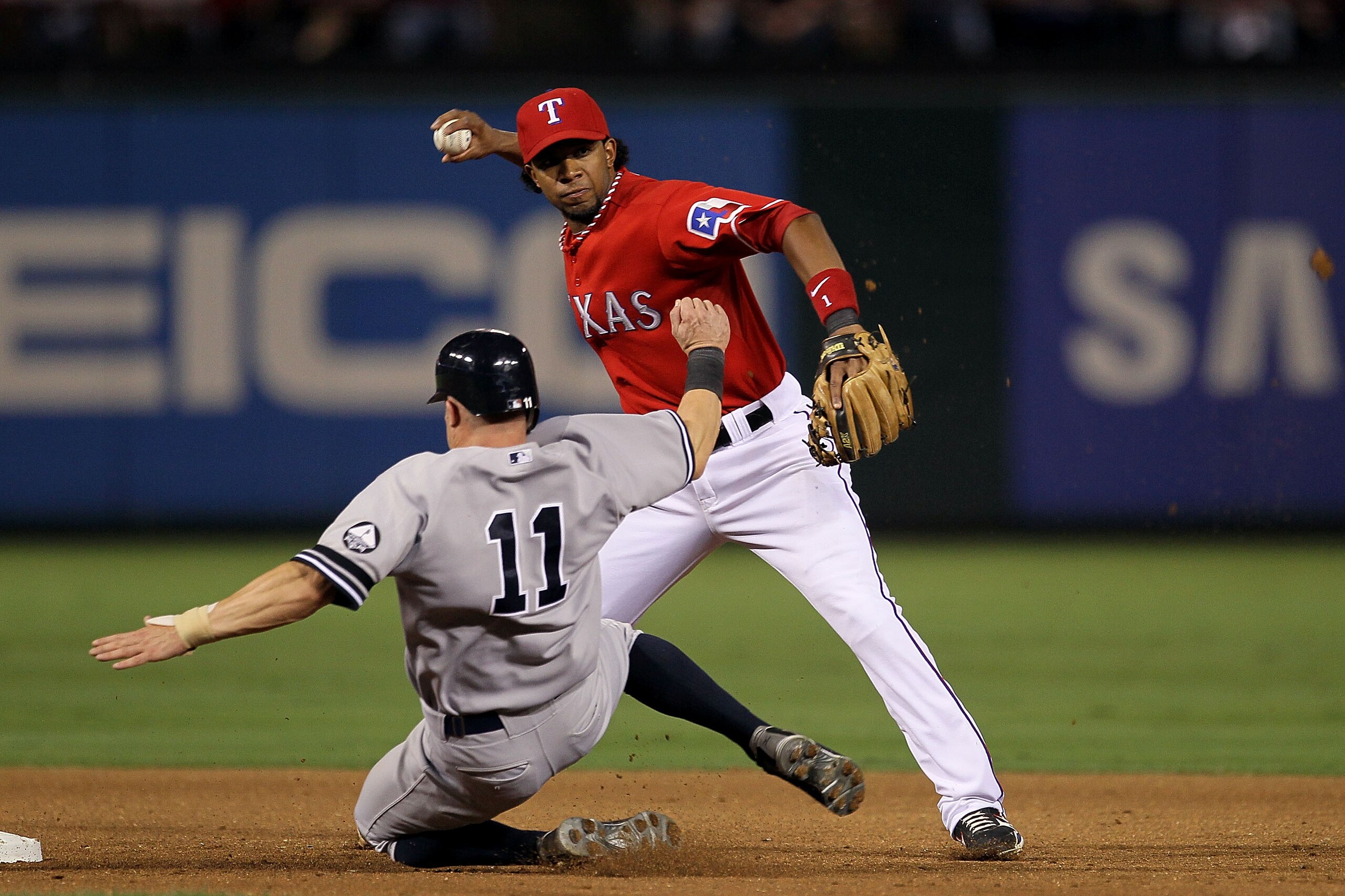 ARLINGTON, TX - OCTOBER 15: Elvis Andrus #1 of the Texas Rangers turns a double play as Brett Gardner #11 of the New York Yankees slides into second base in Game One of the ALCS during the 2010 MLB Playoffs at Rangers Ballpark in Arlington on October 15, ARLINGTON, TX - OCTOBER 15: Elvis Andrus #1 of the Texas Rangers turns a double play as Brett Gardner #11 of the New York Yankees slides into second base in Game One of the ALCS during the 2010 MLB Playoffs at Rangers Ballpark in Arlington on October 15,