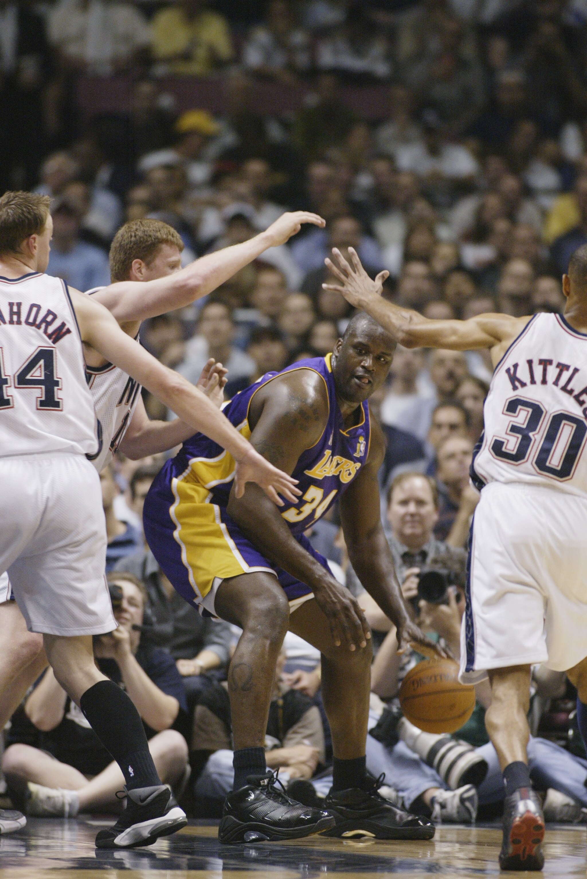 EAST RUTHERFORD, NJ - JUNE 12:  Shaquille O'Neal #34 of the Los Angeles Lakers is defended by Todd MacCulloch #11 of the New Jersey Nets in Game four of the 2002 NBA Finals on June 12, 2002 at Continental Airlines Arena in East Rutherford, New Jersey. The