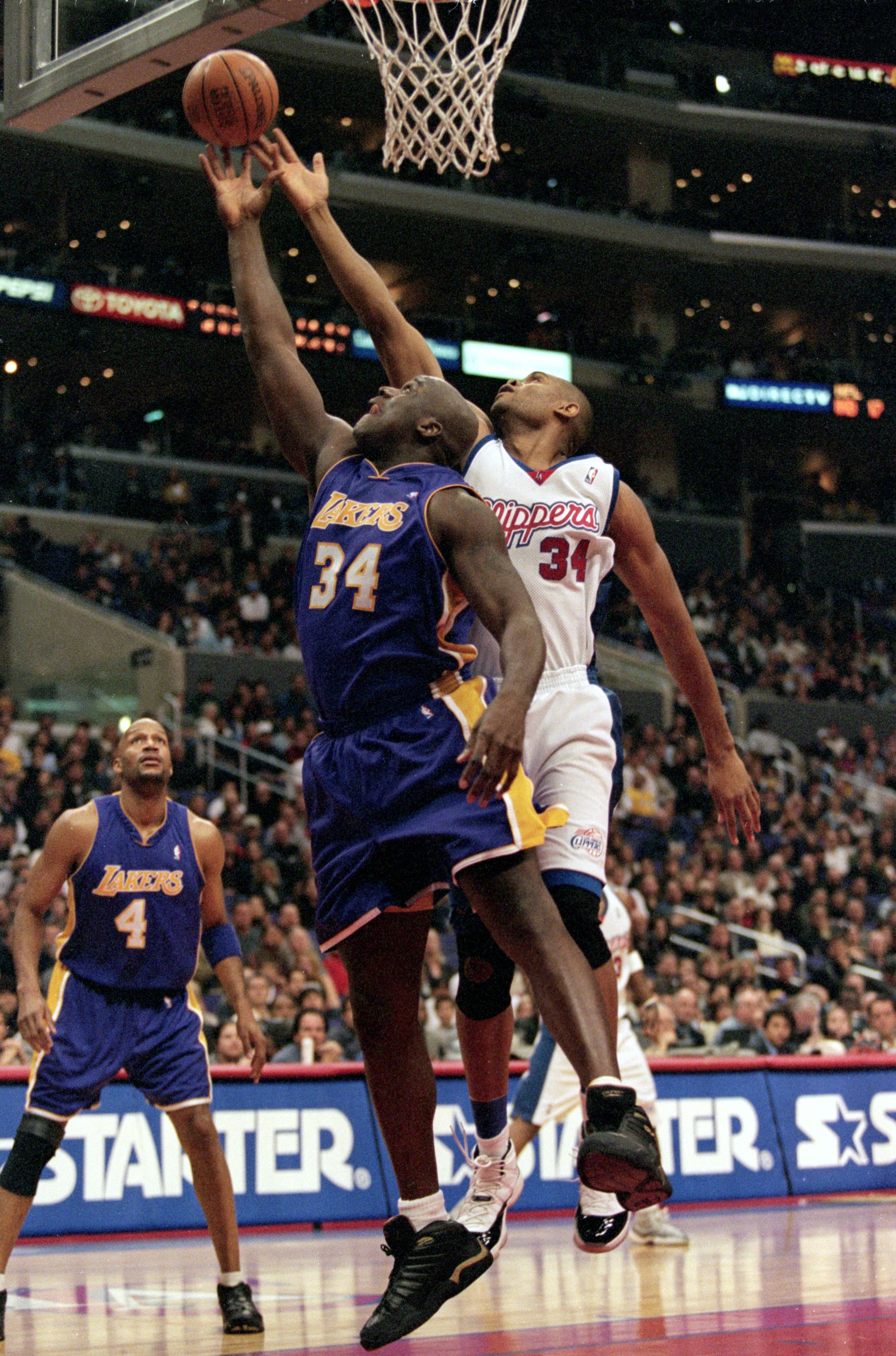 30 Dec 2000: Shaquille O''Neal #34 of the Los Angeles Lakers and Michael Olowokandi #34 of the Los Angeles Clippers jump for the ball by the net during the game at the STAPLES Center in Los Angeles, California. The Lakers defeated the Clippers 116-114. 30 Dec 2000: Shaquille O''Neal #34 of the Los Angeles Lakers and Michael Olowokandi #34 of the Los Angeles Clippers jump for the ball by the net during the game at the STAPLES Center in Los Angeles, California. The Lakers defeated the Clippers 116-114.