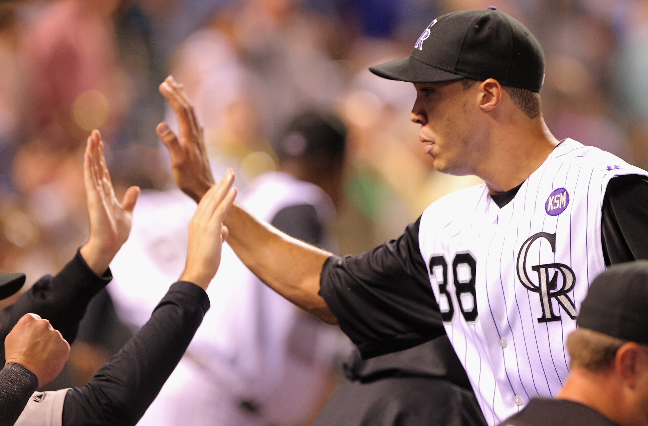 DENVER - SEPTEMBER 27:  Starting pitcher Ubaldo Jimenez #38 of the Colorado Rockies is welcomed back to the dugout at the end of the seventh inning against the Los Angeles Dodgers at Coors Field on September 25, 2010 in Denver, Colorado. Jiimenez failed t