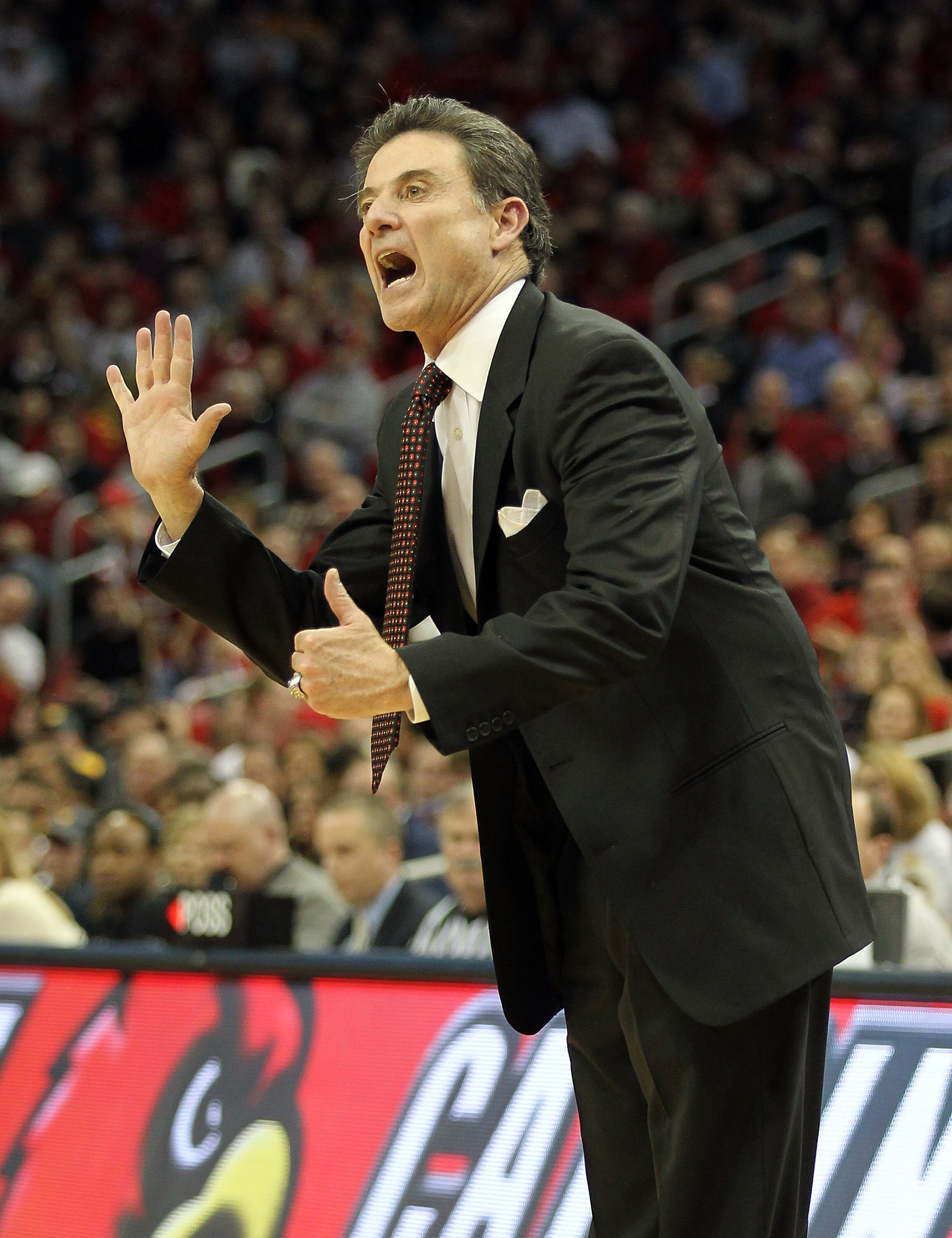 LOUISVILLE, KY - JANUARY 26:  Rick Pitino the Head Coach of the Louisville Cardinals gives instructions to his team during the Big East Conference game against the West Virginia Mountaineers at the KFC Yum! Center on January 26, 2011 in Louisville, Kentuc