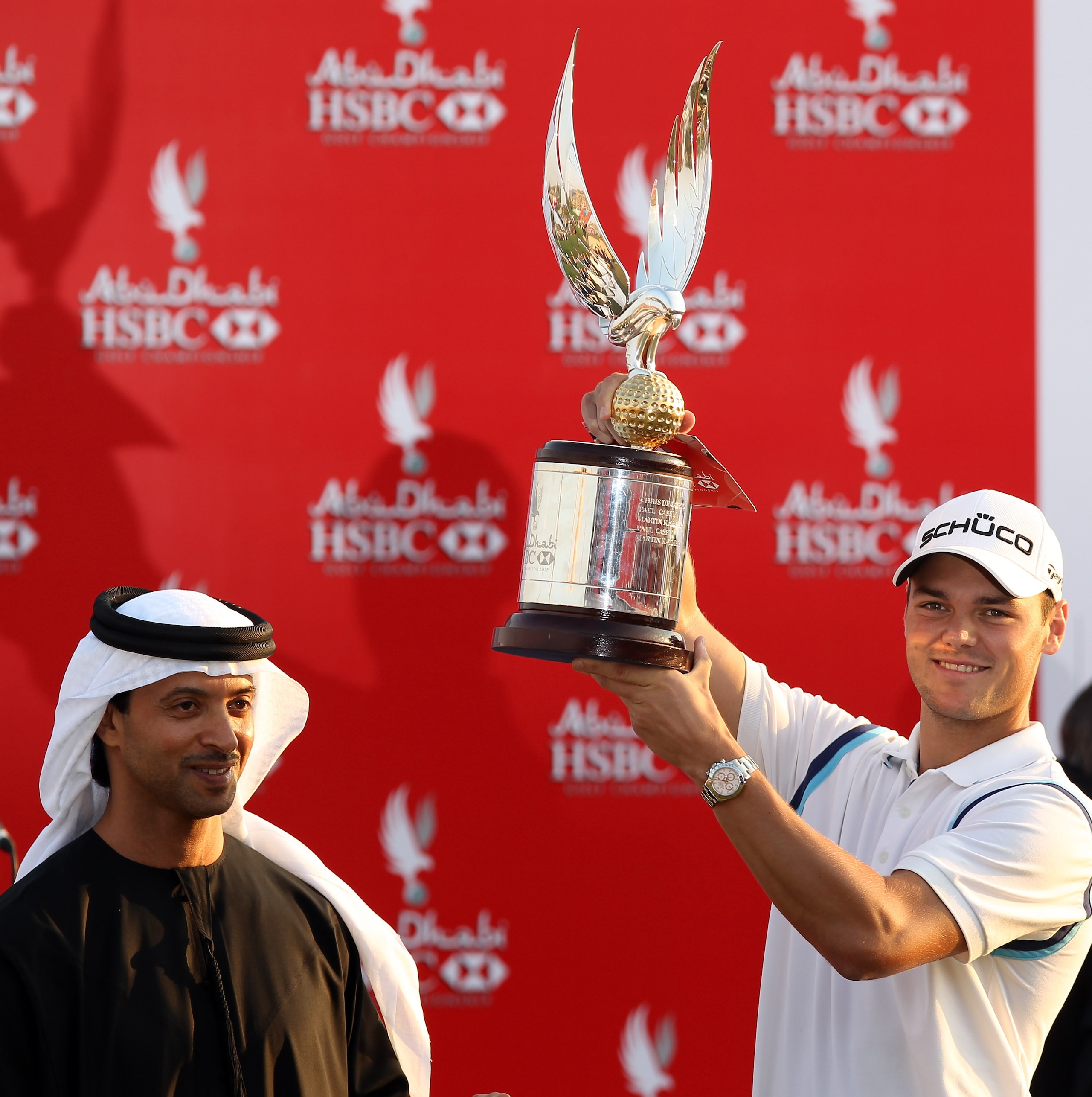 ABU DHABI, UNITED ARAB EMIRATES - JANUARY 23:  Martin Kaymer of Germany is presented with the trophy by His Highness Sheikh Hazza Bin Zayed Al Nahyan The National Security Advisor, Vice Chairman of the Executive Council, and Chairman of the Abu Dhabi Spor
