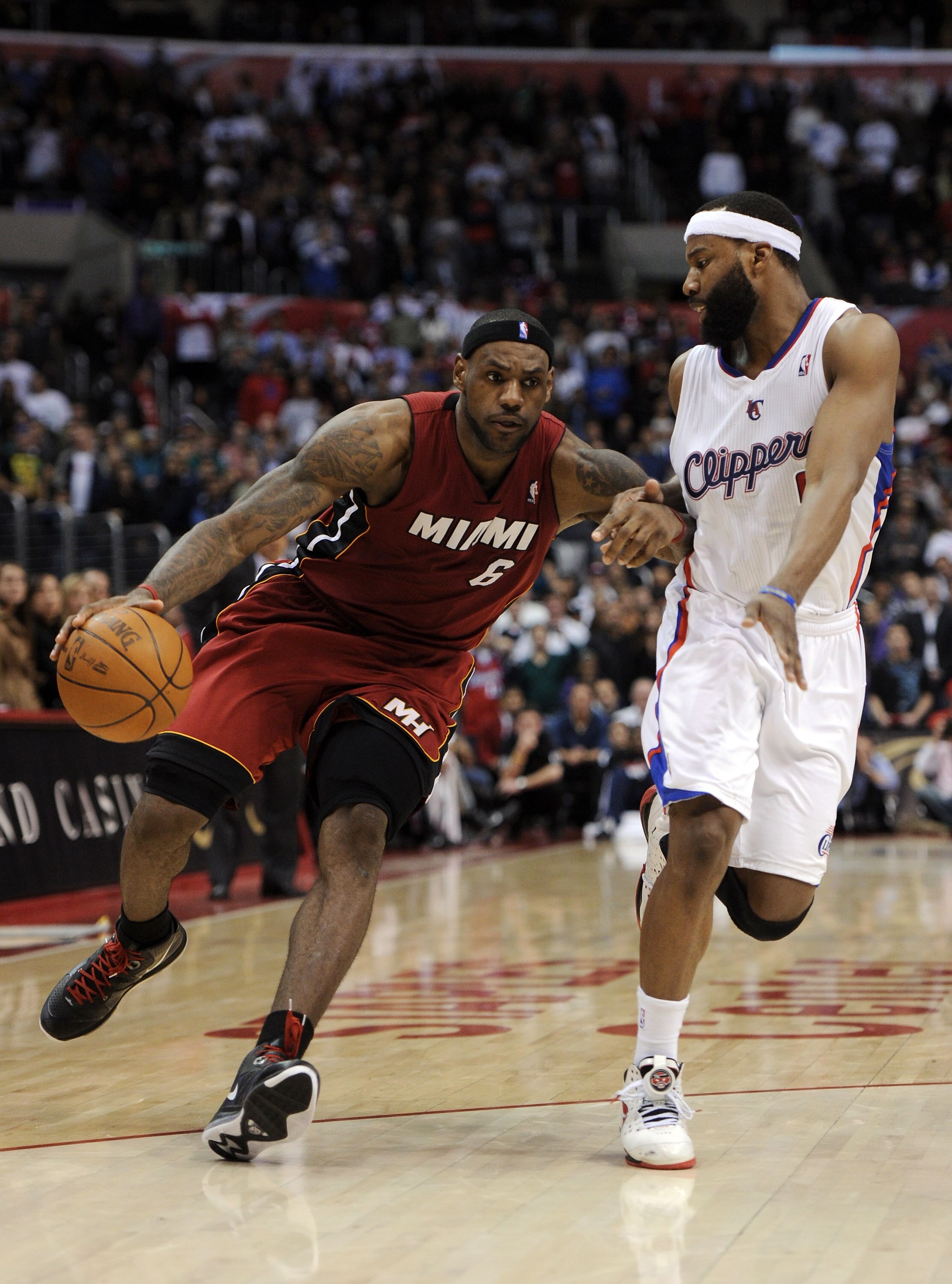 LOS ANGELES, CA - JANUARY 12:  LeBron James #6 of the Miami Heat dribbles around Baron Davis #5 of the Los Angeles Clippers at Staples Center on January 12, 2011 in Los Angeles, California.  NOTE TO USER: User expressly acknowledges and agrees that, by do