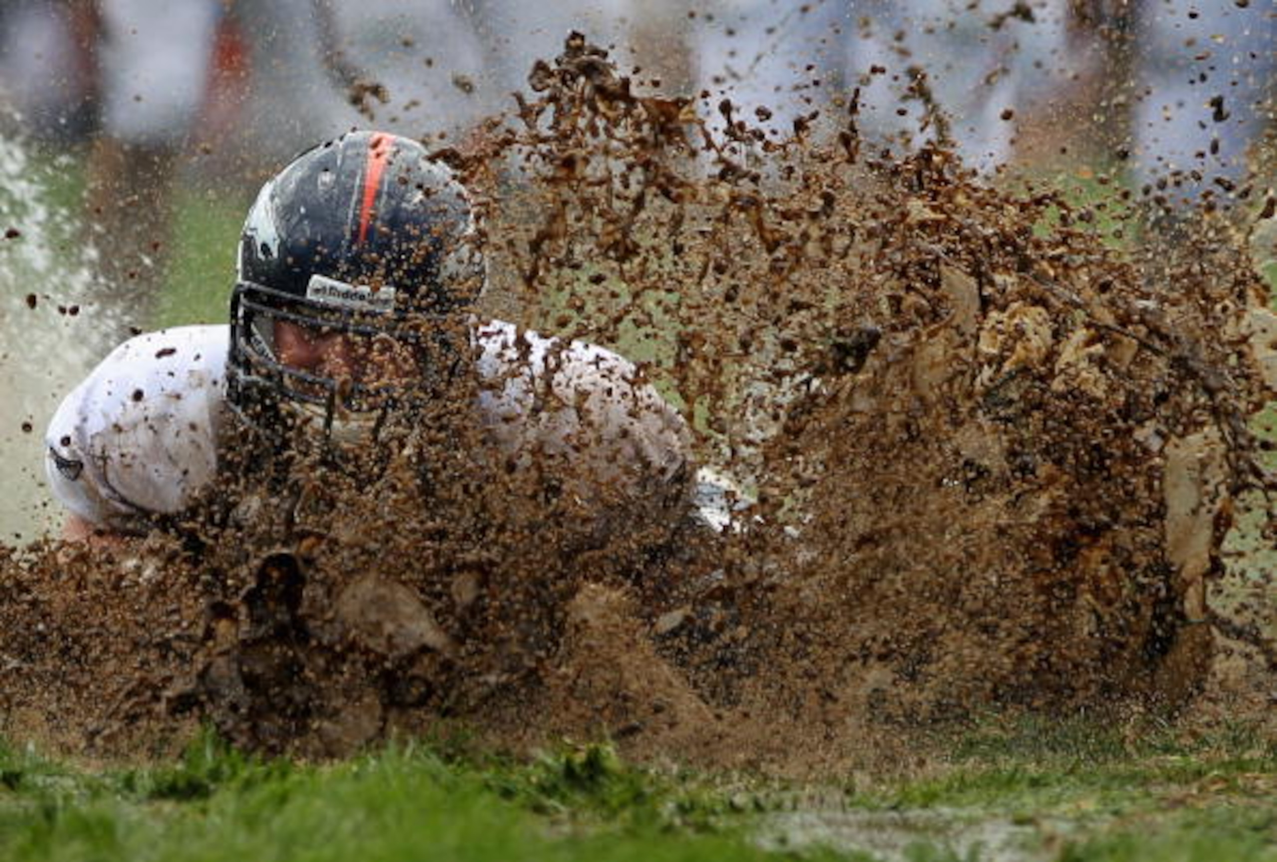 ENGLEWOOD, CO - AUGUST 05:  Zane Beadles #68 of the Denver Broncos dives into the mud as rookies partake in the slip and slide fumble drill during training camp at Dove Valley on August 5, 2010 in Englewood, Colorado.  (Photo by Doug Pensinger/Getty Image