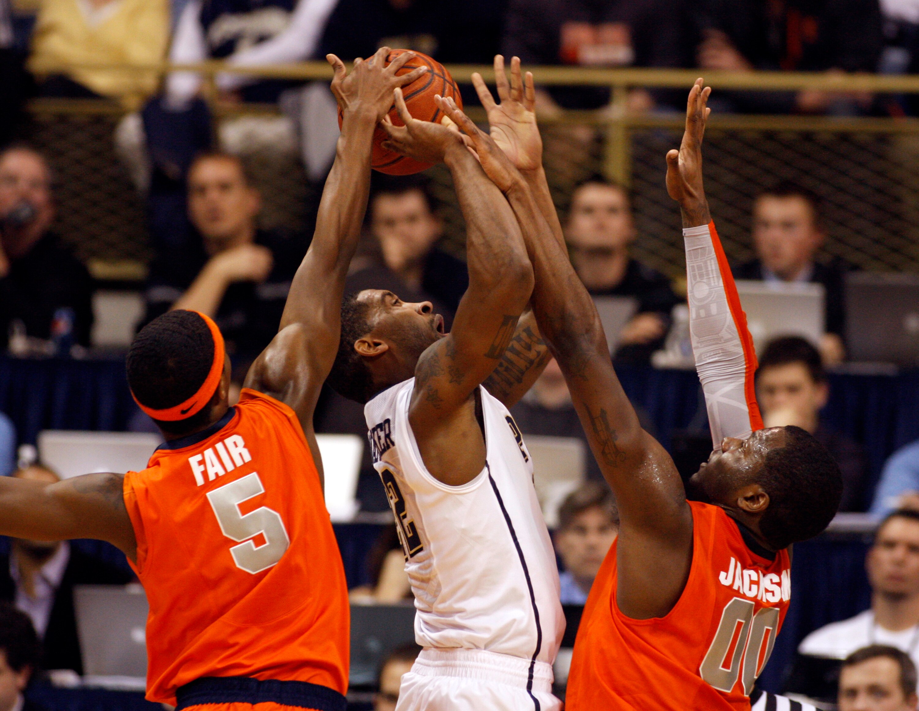 PITTSBURGH, PA - JANUARY 17:  Brad Wanamaker #22 of the Pittsburgh Panthers battles to the basket against C.J. Fair #5 and Rick Jackson #0 of the Syracuse Orange at Petersen Events Center on January 17, 2011 in Pittsburgh, Pennsylvania.  The Panthers defe