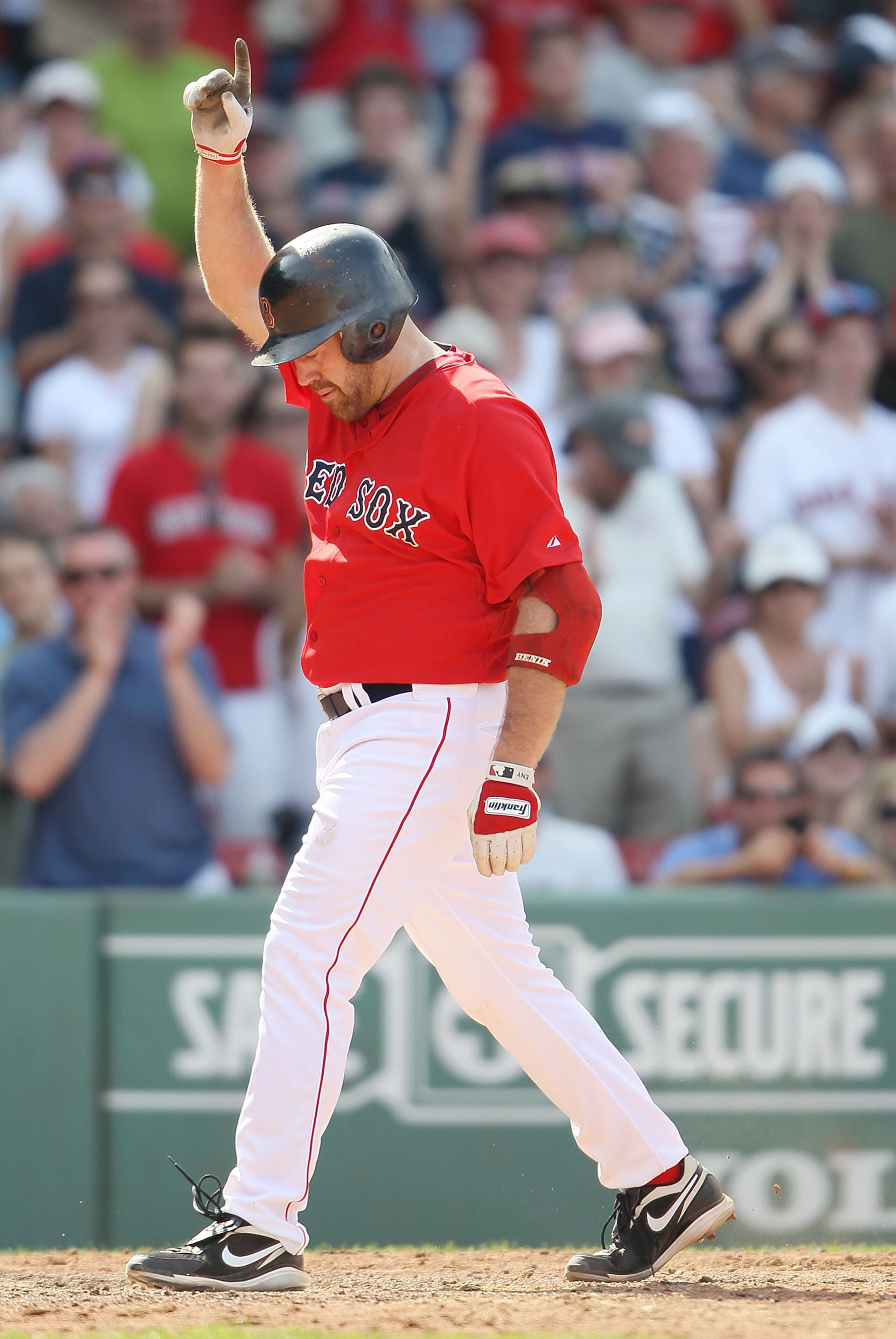 BOSTON - JULY 04:  Kevin Youkilis #20 of the Boston Red Sox celebrates his solo home run in the ninth inning against the Baltimore Orioles on July 4, 2010 at Fenway Park in Boston, Massachusetts. The Orioles defeated the Red Sox 6-1.  (Photo by Elsa/Getty
