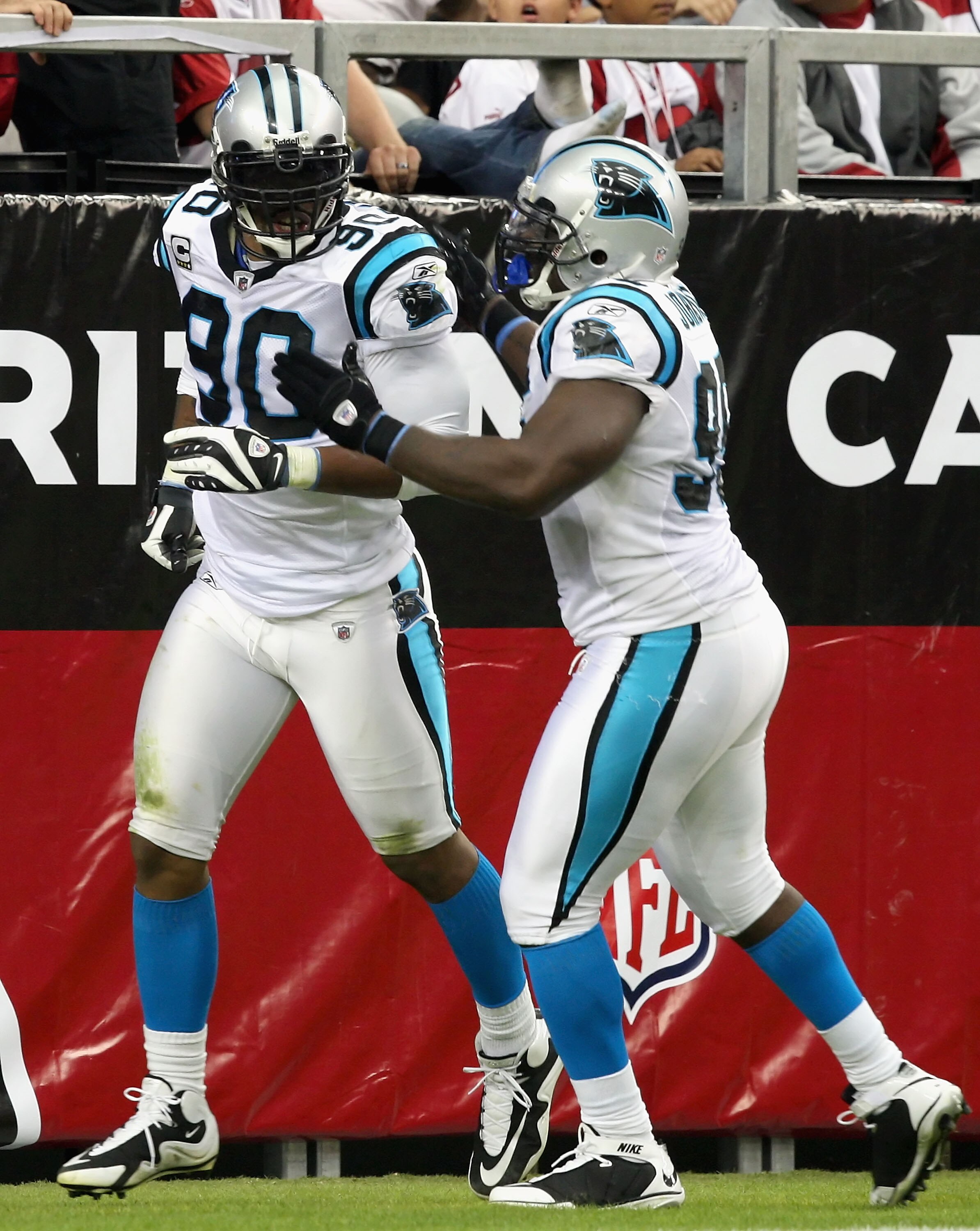 GLENDALE, AZ - NOVEMBER 01:  Defensive end Julius Peppers #90 of the Carolina Panthers celebrates with Charles Johnson #95 after Peppers scored on a 13 yard touchdown interception against the Arizona Cardinals during the NFL game at the Universtity of Pho