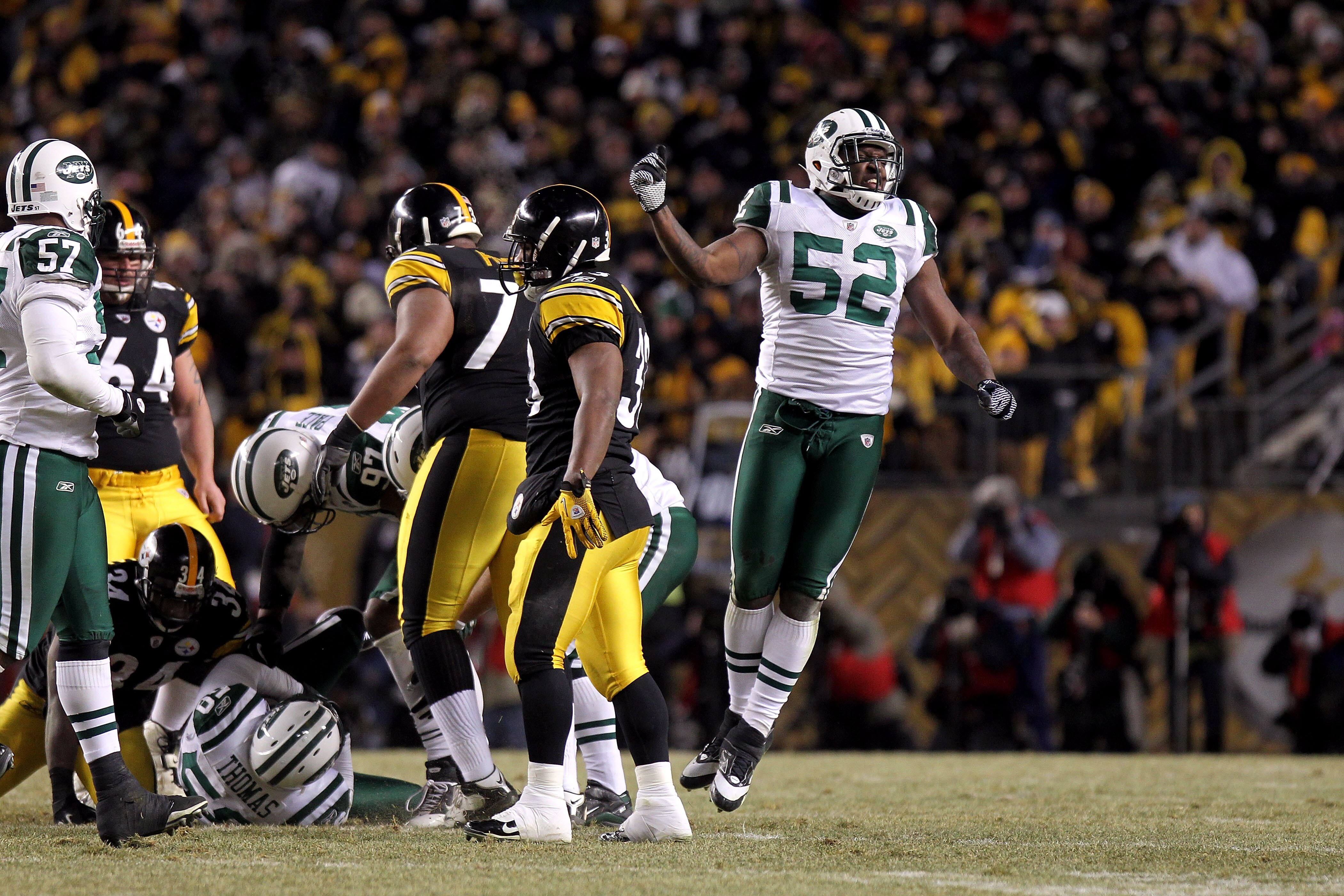 PITTSBURGH, PA - JANUARY 23:  David Harris #52 of the New York Jets reacts after an interception by Bryan Thomas #58 against the Pittsburgh Steelers during the 2011 AFC Championship game at Heinz Field on January 23, 2011 in Pittsburgh, Pennsylvania. The