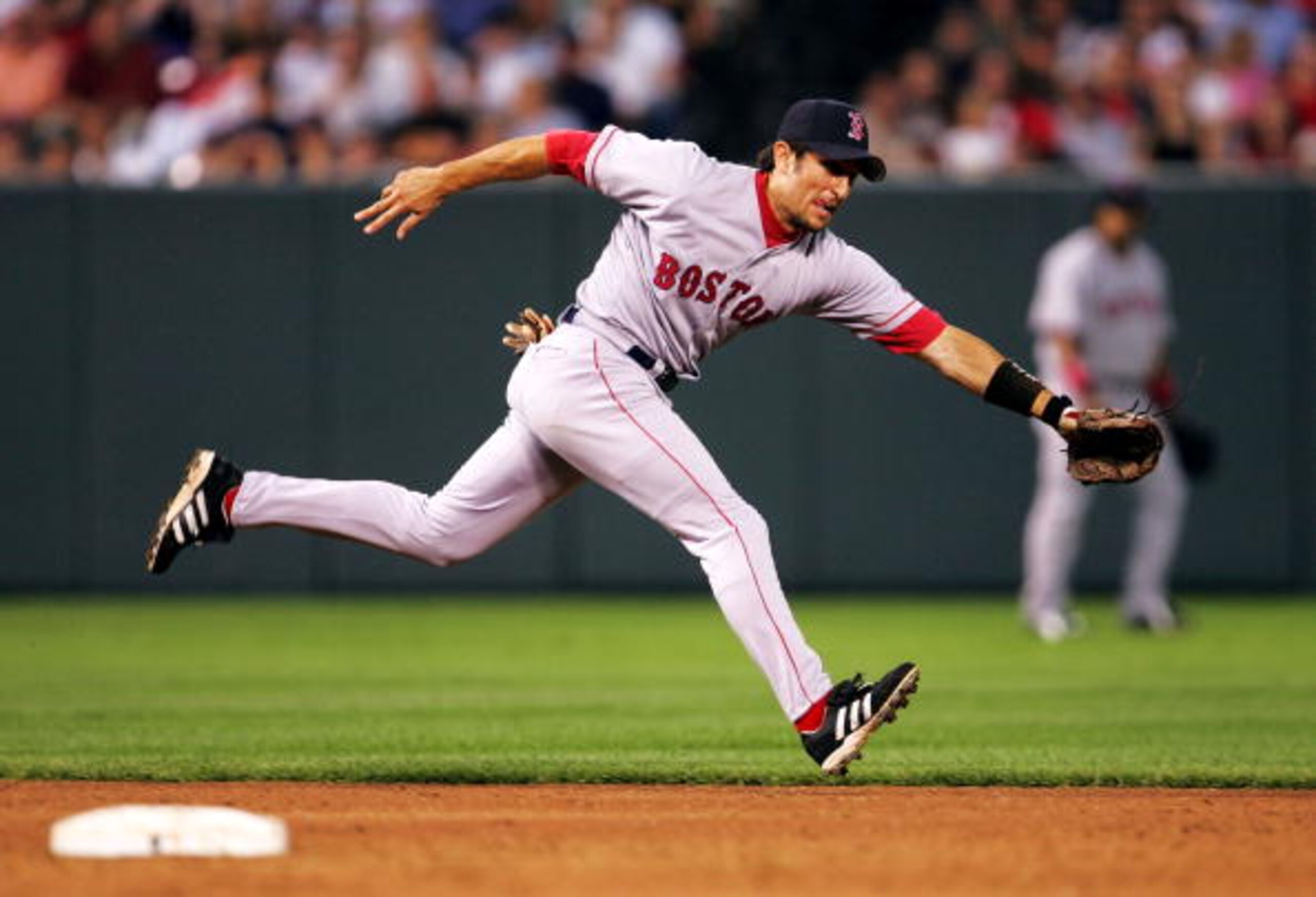 BALTIMORE - JULY 26:   Nomar Garciaparra #5 of the Boston Red Sox lunges for a ball during the 3rd inning against the Baltimore Orioles July 26, 2004 at Camden Yards in Baltimore, Maryland.  (Photo by Jamie Squire/Getty Images)