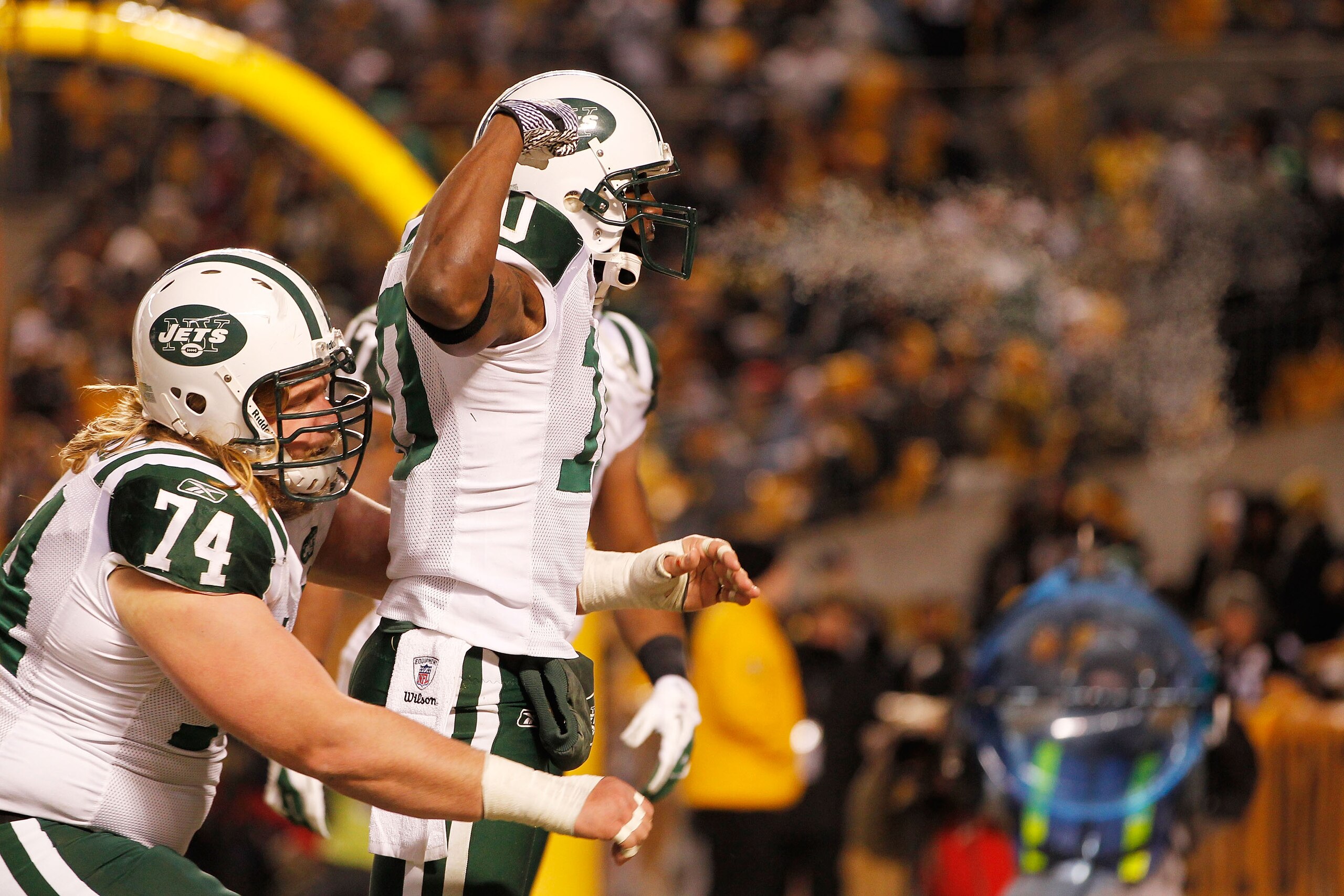 PITTSBURGH, PA - JANUARY 23:  Santonio Holmes #10, Braylon Edwards #17 and Nick Mangold #74 of the New York Jets celebrate after Holmes scored a third quarter touchdown against the Pittsburgh Steelers during the 2011 AFC Championship game at Heinz Field o