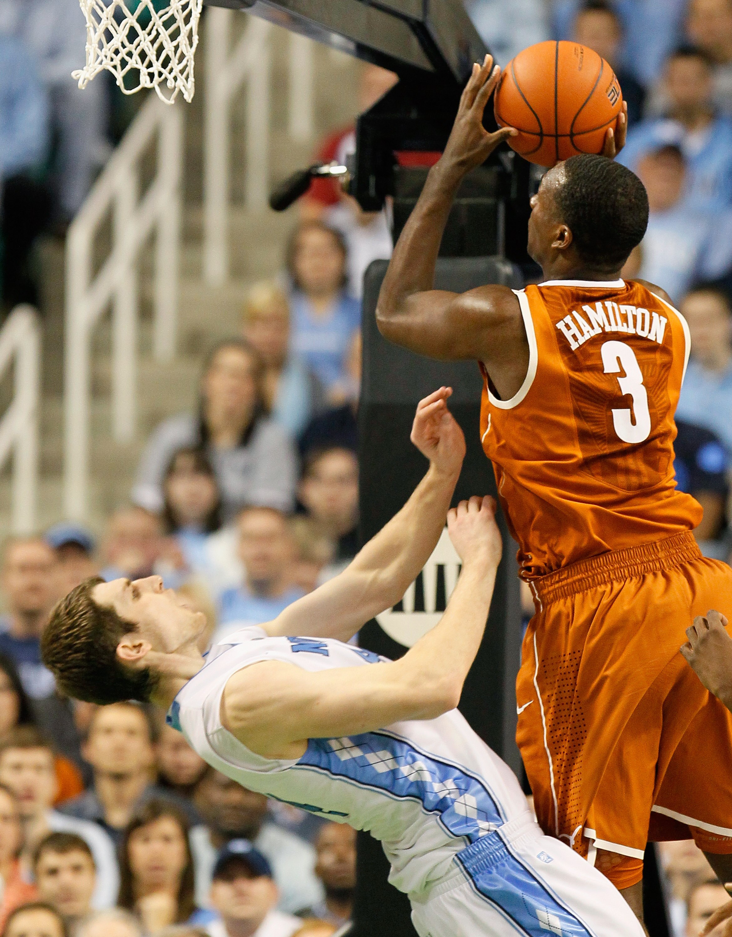 GREENSBORO, NC - DECEMBER 18:  Tyler Zeller #44 of the North Carolina Tar Heels takes a charge from Jordan Hamilton #3 of the Texas Longhorns at Greensboro Coliseum on December 18, 2010 in Greensboro, North Carolina.  (Photo by Kevin C. Cox/Getty Images)
