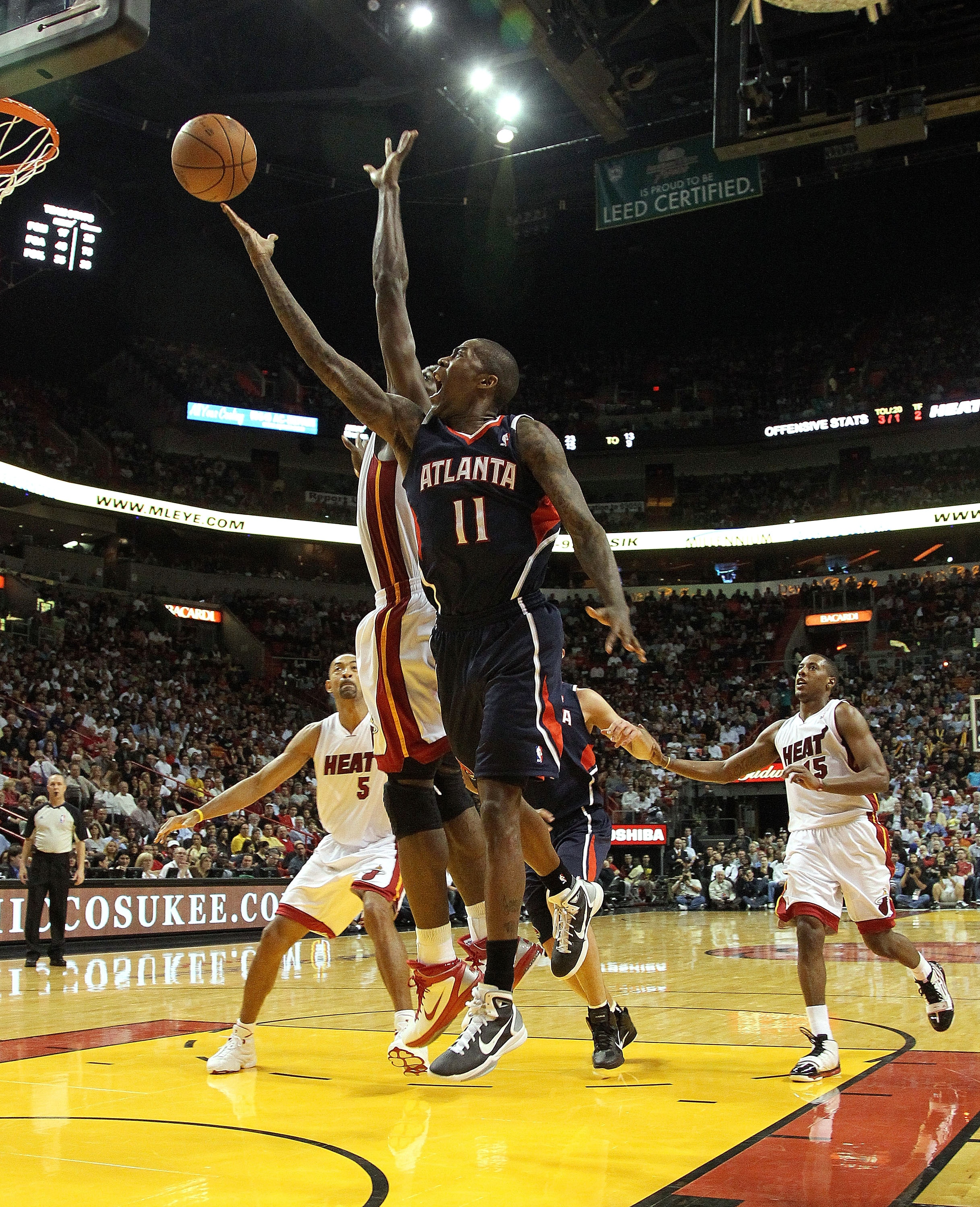 MIAMI, FL - JANUARY 18:  Jamal Crawford #11 of the Atlanta Hawks shoots over Dwyane Wade #3 of the Miami Heat during a game at American Airlines Arena on January 18, 2011 in Miami, Florida. NOTE TO USER: User expressly acknowledges and agrees that, by dow