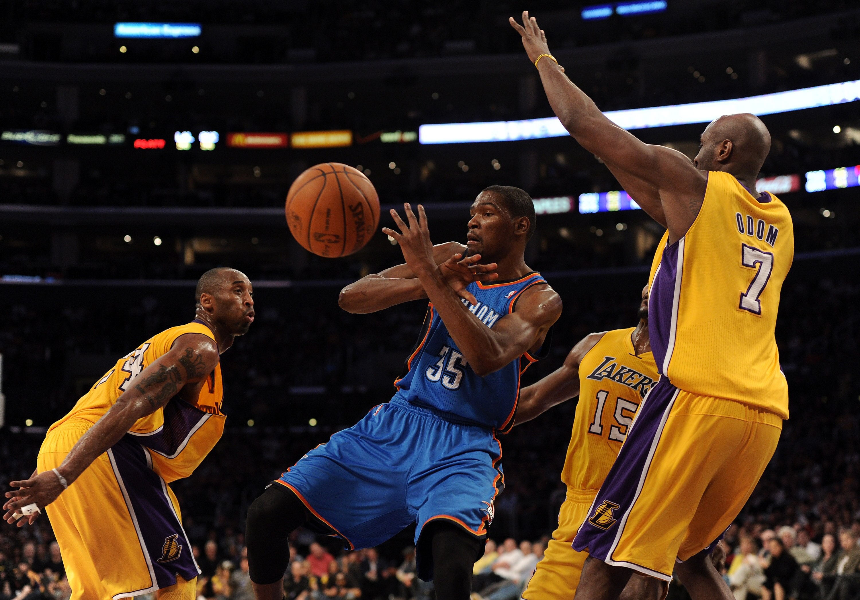 LOS ANGELES, CA - JANUARY 17:  Kevin Durant #35 of the Oklahoma City Thunder has the ball knocked away by Kobe Bryant #24 and Lamar Odom #7 of the Los Angeles Lakers at the Staples Center on January 17, 2011 in Los Angeles, California.   NOTE TO USER: Use