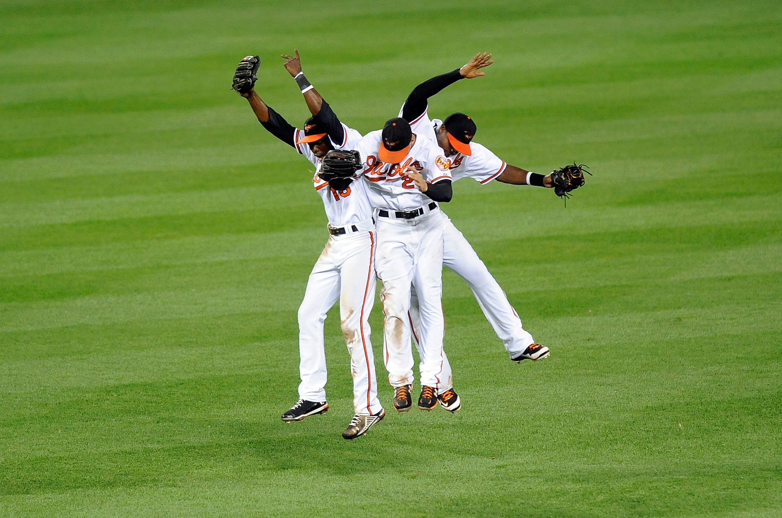 BALTIMORE - AUGUST 04:  Felix Pie #18, Nick Markakis #21 and Adam Jones #10 of the Baltimore Orioles celebrate after a 9-7 victory against the Los Angeles Angels of Anaheim at Camden Yards on August 4, 2010 in Baltimore, Maryland.  (Photo by Greg Fiume/Ge