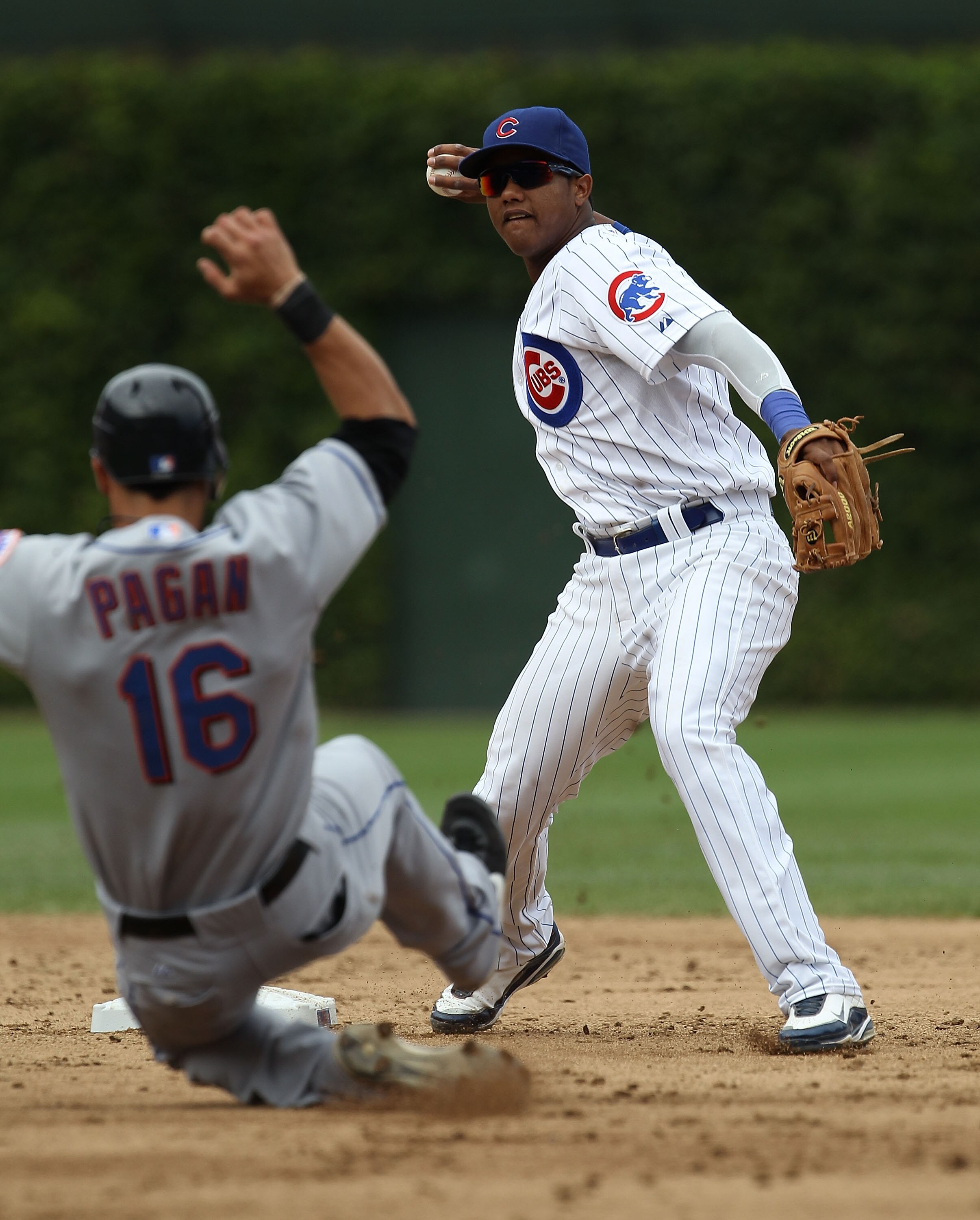 CHICAGO - SEPTEMBER 05: Starlin Castro #13 of the Chicago Cubs turns a double play as Angel Pagan #16 of the New York Mets slides into 2nd base at Wrigley Field on September 5, 2010 in Chicago, Illinois. (Photo by Jonathan Daniel/Getty Images)