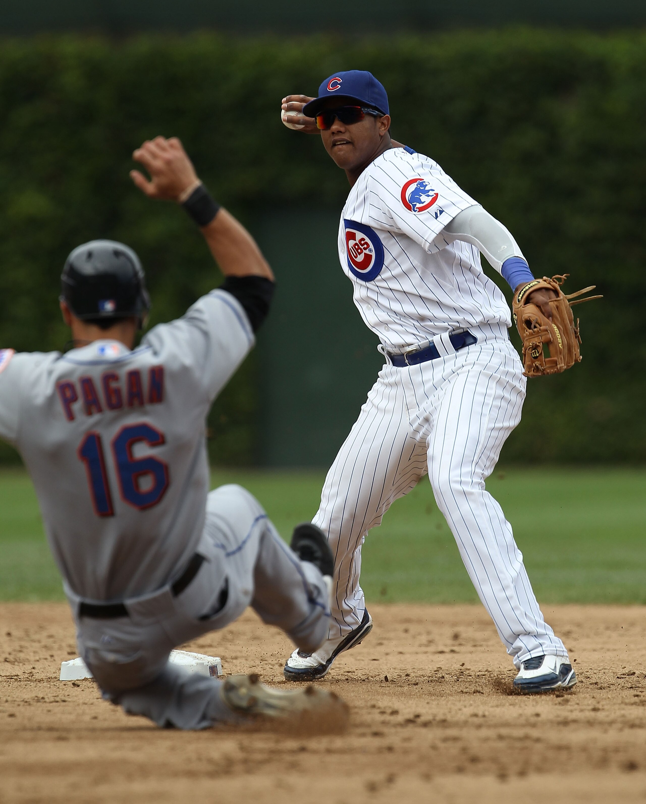 CHICAGO - SEPTEMBER 05: Starlin Castro #13 of the Chicago Cubs turns a double play as Angel Pagan #16 of the New York Mets slides into 2nd base at Wrigley Field on September 5, 2010 in Chicago, Illinois. (Photo by Jonathan Daniel/Getty Images)