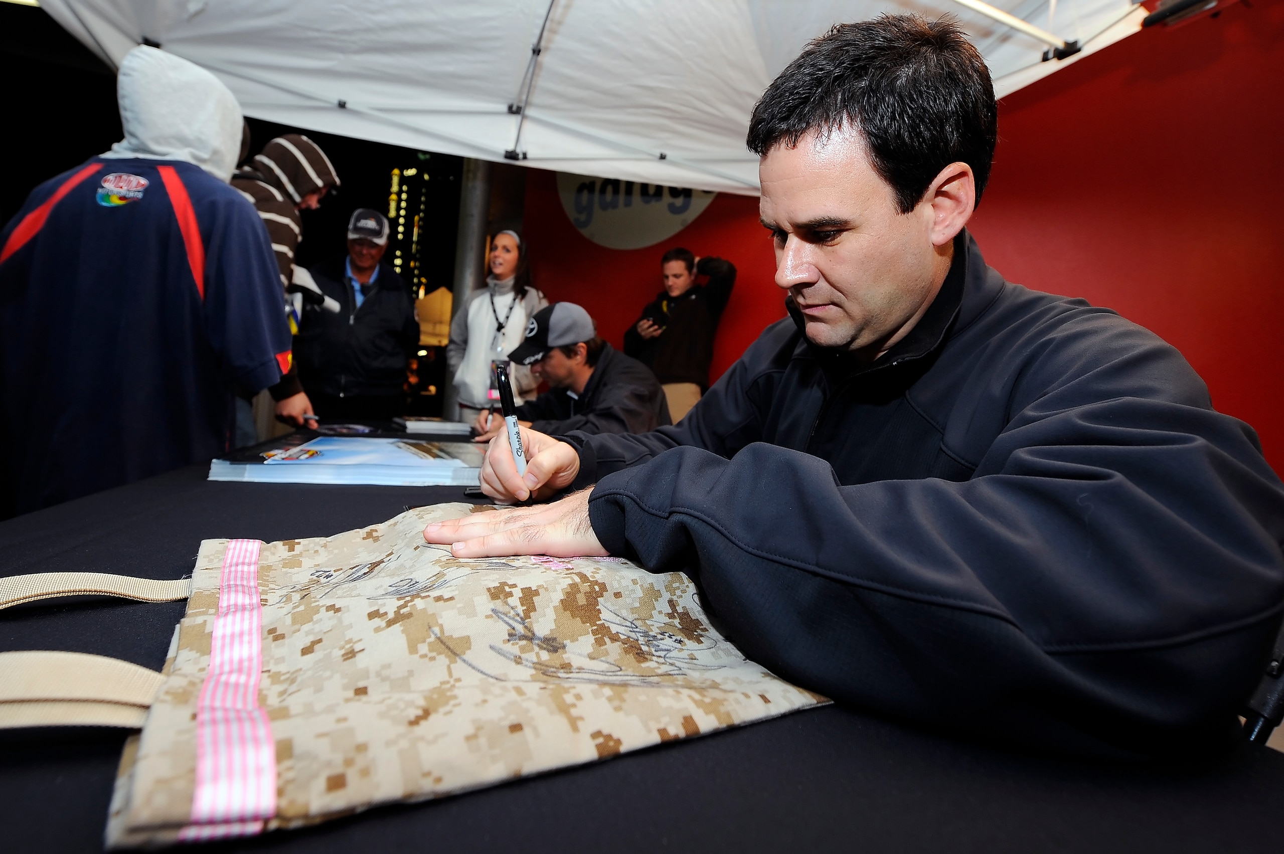 DAYTONA BEACH, FL - JANUARY 21: Kevin Conway signs autographs for fans at Daytona International Speedway on January 21, 2011 in Daytona Beach, Florida. (Photo by Jared C. Tilton/Getty Images for NASCAR) DAYTONA BEACH, FL - JANUARY 21: Kevin Conway signs autographs for fans at Daytona International Speedway on January 21, 2011 in Daytona Beach, Florida. (Photo by Jared C. Tilton/Getty Images for NASCAR)