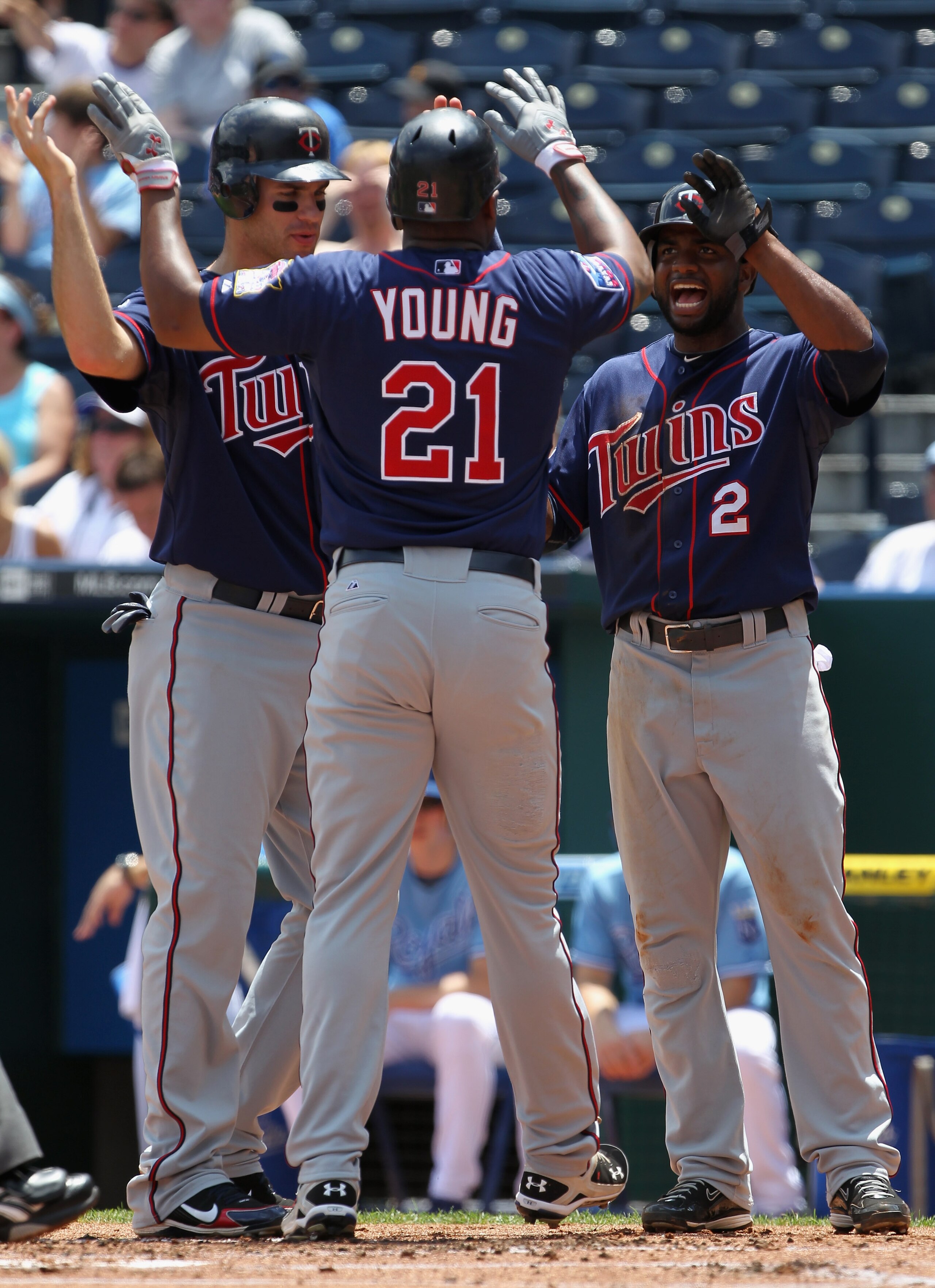 KANSAS CITY, MO - JULY 28:  Delmon Young #21 of the Minnesota Twins is congratulated by Joe Mauer #7 and Denard Span #2 after hitting a 3-run home run during the 1st inning of the game against the Kansas City Royals on July 28, 2010 at Kauffman Stadium in