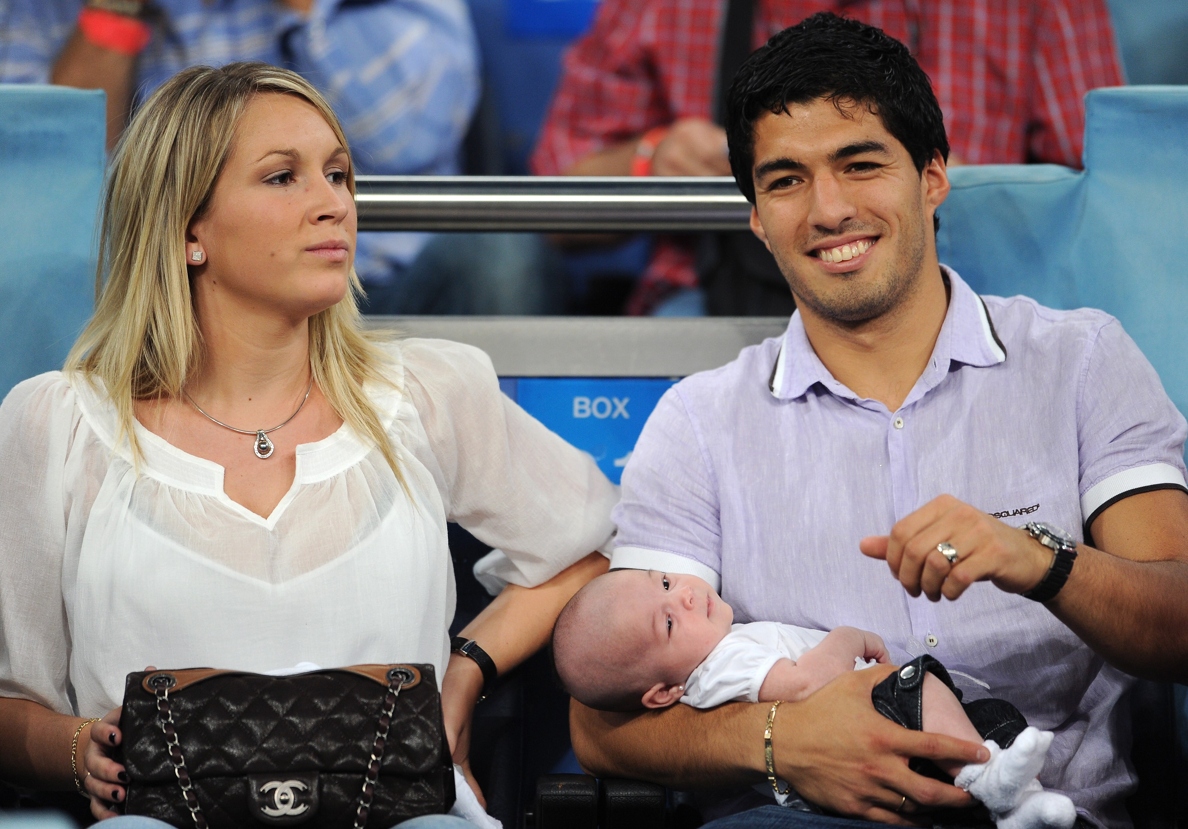 MADRID, SPAIN - SEPTEMBER 15:  Expelled Ajax player Luis Suarez (R) hold his baby daughter Delfina while seated next to his wife Sofia prior to the start of the UEFA Champions League group G match between Real Madrid and Ajax at the Estadio Santiago Berna