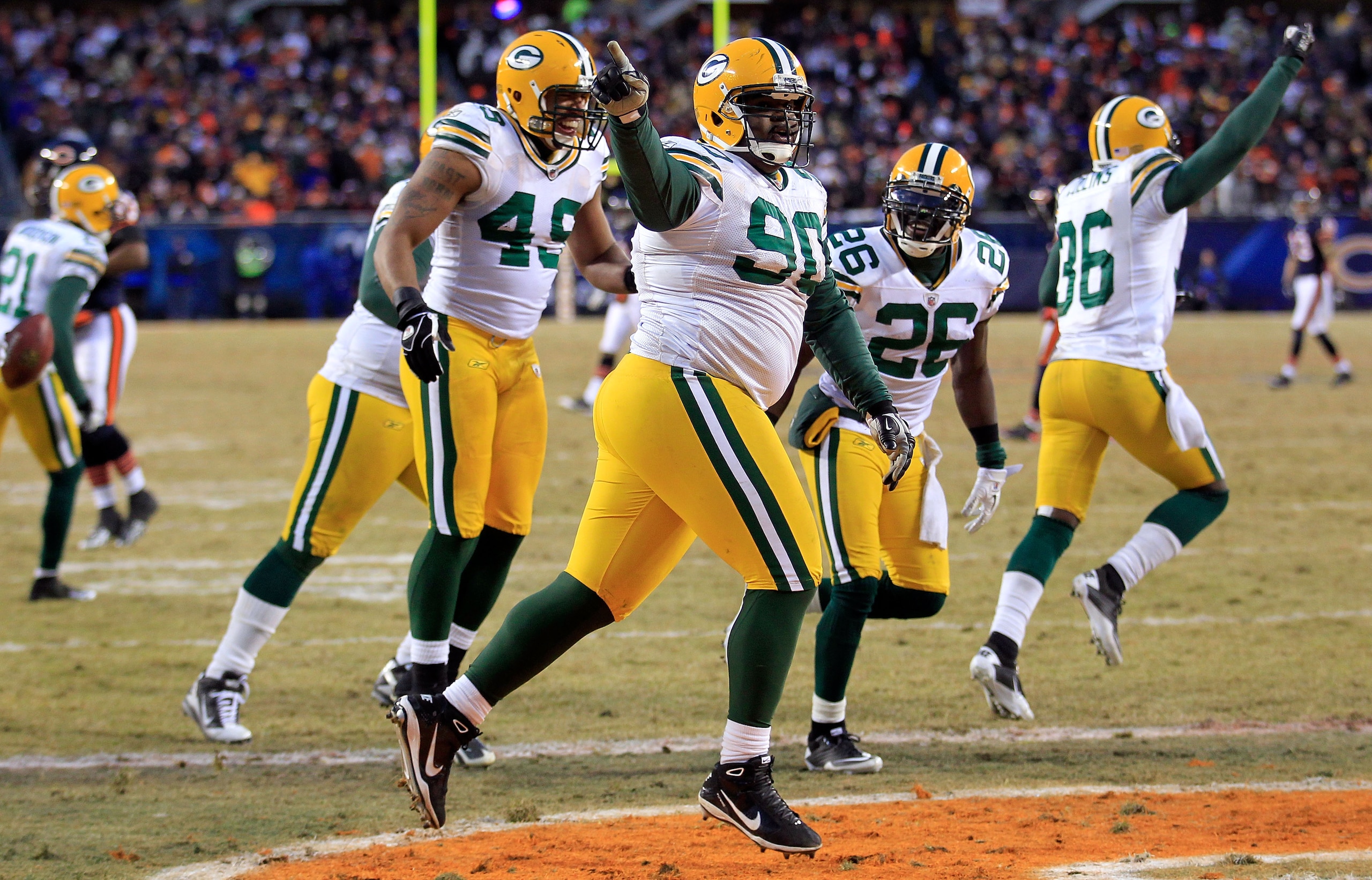 CHICAGO, IL - JANUARY 23:  B.J. Raji #90 of the Green Bay Packers reacts with teammates after scoring on a 18-yard interception return for a touchdown in the fourth quarter against the Chicago Bears in the NFC Championship Game at Soldier Field on January