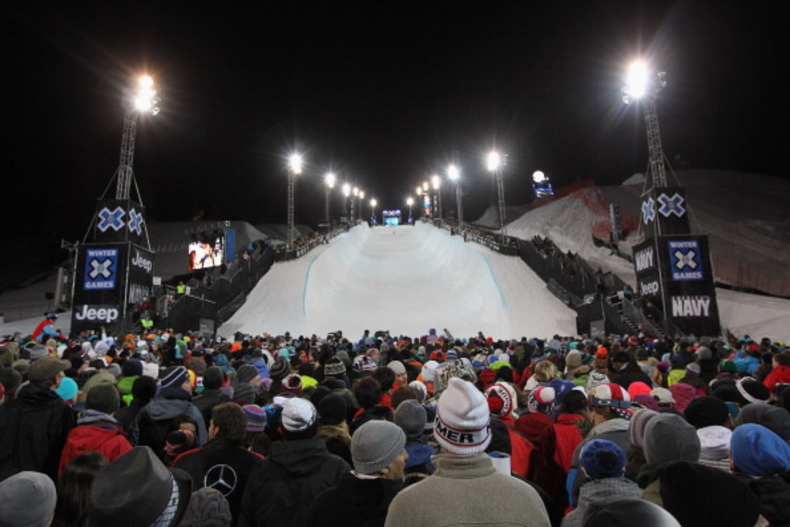 ASPEN, CO - JANUARY 30: Fans fill the venue as Shaun White of Carlsbad, California made history with his four-peat gold medal in the Men's Snowboard Superpipe at Winter X Games 15 at Buttermilk Mountain on January 30, 2011 in Aspen, Colorado. Fans also s ASPEN, CO - JANUARY 30: Fans fill the venue as Shaun White of Carlsbad, California made history with his four-peat gold medal in the Men's Snowboard Superpipe at Winter X Games 15 at Buttermilk Mountain on January 30, 2011 in Aspen, Colorado. Fans also s