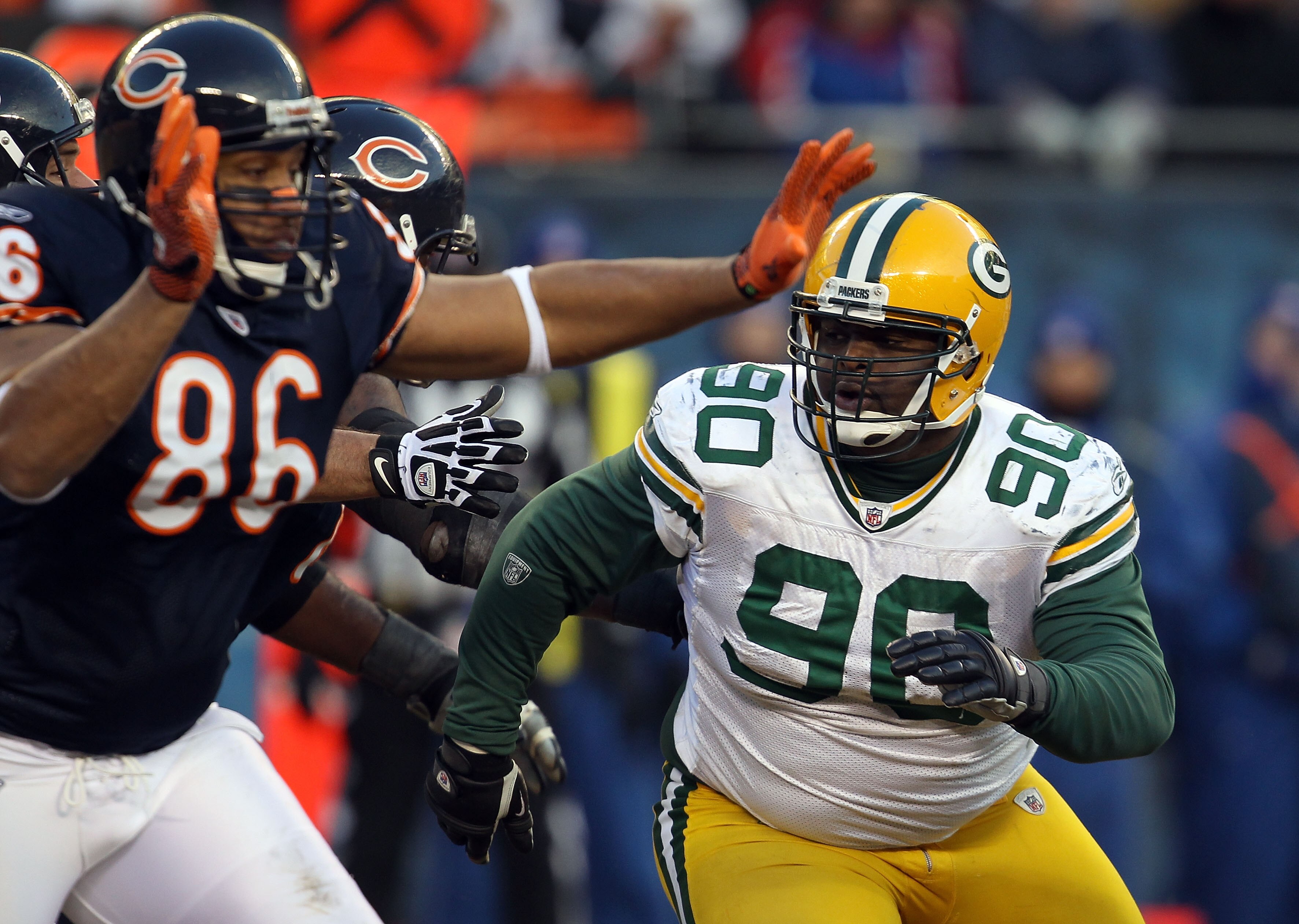 CHICAGO, IL - JANUARY 23:  B.J. Raji #90 of the Green Bay Packers rushes in on Brandon Manumaleuna #86 of the Chicago Bears in the NFC Championship Game at Soldier Field on January 23, 2011 in Chicago, Illinois.  (Photo by Jonathan Daniel/Getty Images)
