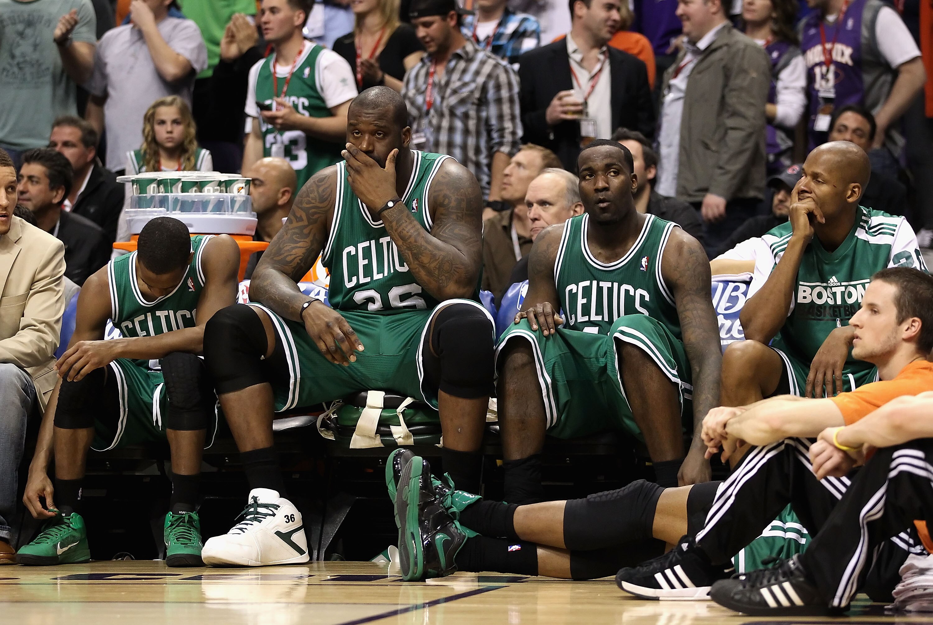 PHOENIX, AZ - JANUARY 28:  (L-R) Rajon Rondo #9, Shaquille O'Neal #36, Kendrick Perkins #43 and Ray Allen #20 of the Boston Celtics react while sitting on the bench during the NBA game against the Phoenix Suns at US Airways Center on January 28, 2011 in P