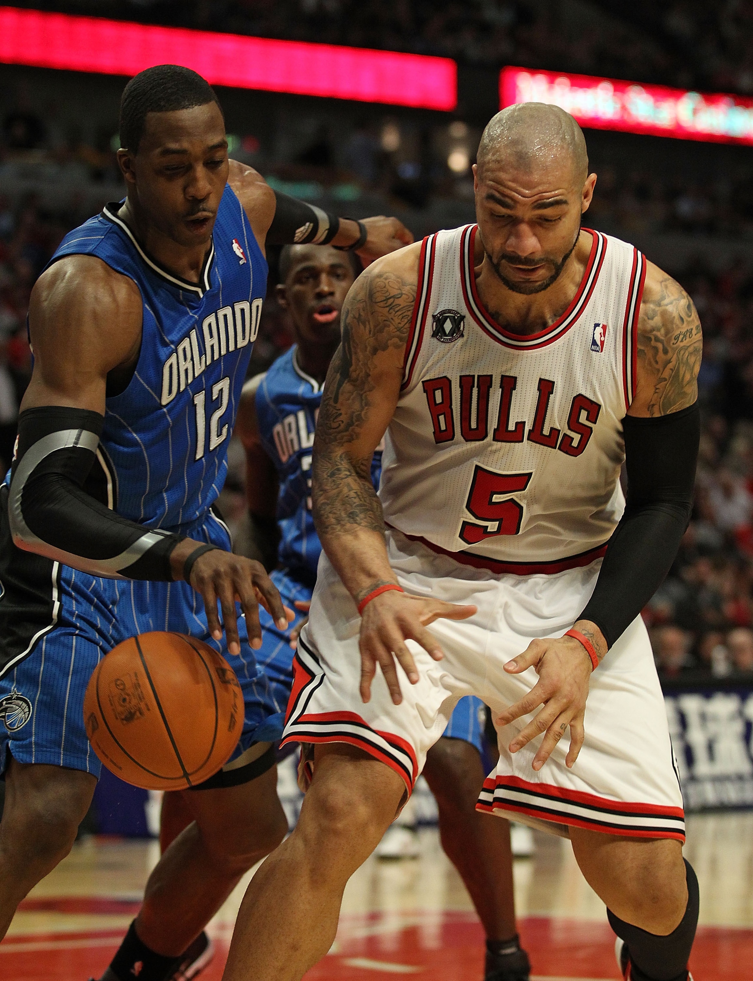 CHICAGO, IL - JANUARY 28: Dwight Howard #12 of the Orlando Magic knocks the ball away from Carlos Boozer #5 of the Chicago Bulls at the United Center on January 28, 2011 in Chicago, Illinois. The Bulls defeated the Magic 99-90. NOTE TO USER: User expressl