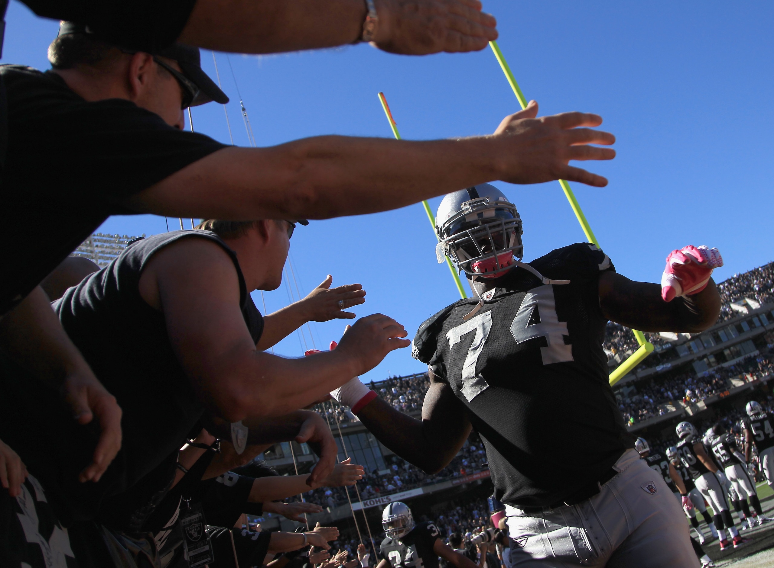 OAKLAND, CA - OCTOBER 10: Bruce Campbell #74 of the Oakland Raiders high fives fans before their game against the San Diego Chargers at Oakland-Alameda County Coliseum on October 10, 2010 in Oakland, California. (Photo by Ezra Shaw/Getty Images) OAKLAND, CA - OCTOBER 10: Bruce Campbell #74 of the Oakland Raiders high fives fans before their game against the San Diego Chargers at Oakland-Alameda County Coliseum on October 10, 2010 in Oakland, California. (Photo by Ezra Shaw/Getty Images)