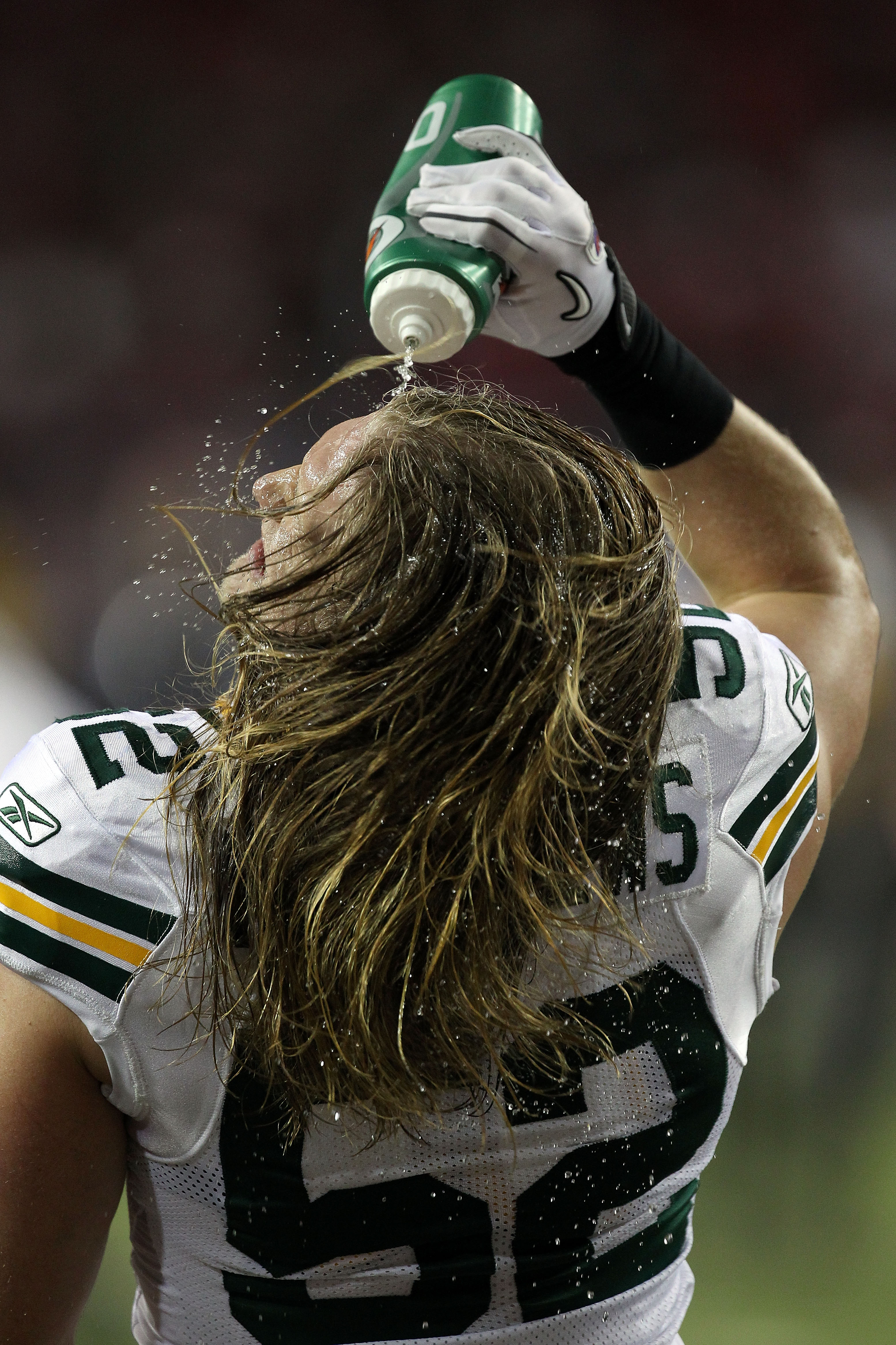 ATLANTA, GA - JANUARY 15:  Clay Matthews #52 of the Green Bay Packers squirts water on his face durign wamr ups against the Atlanta Falcons during their 2011 NFC divisional playoff game at Georgia Dome on January 15, 2011 in Atlanta, Georgia.  (Photo by S
