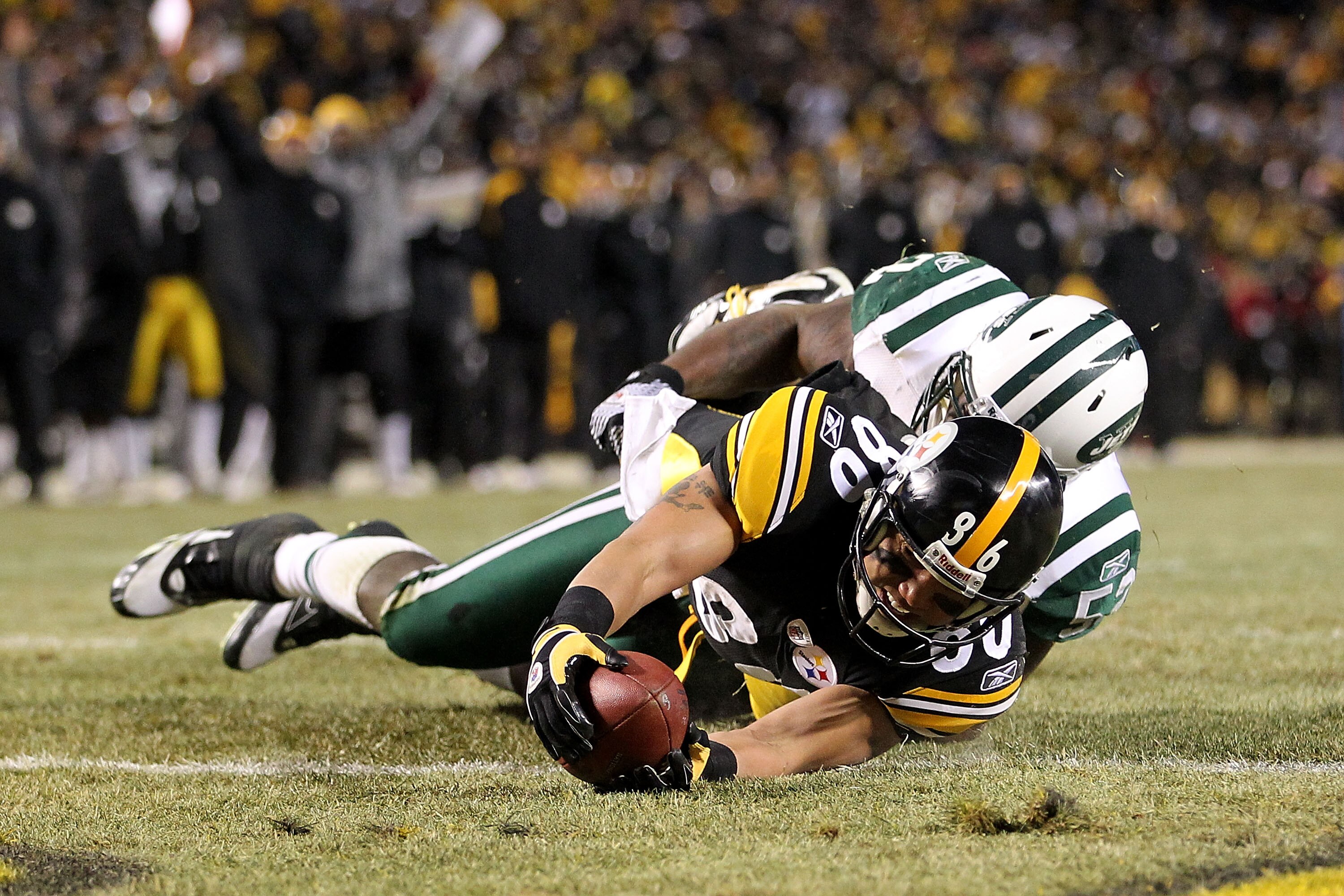 PITTSBURGH, PA - JANUARY 23:  Hines Ward #86 of the Pittsburgh Steelers catches the ball and is down on the one-yard line as he is tackled by David Harris #52 of the New York Jets during the 2011 AFC Championship game at Heinz Field on January 23, 2011 in