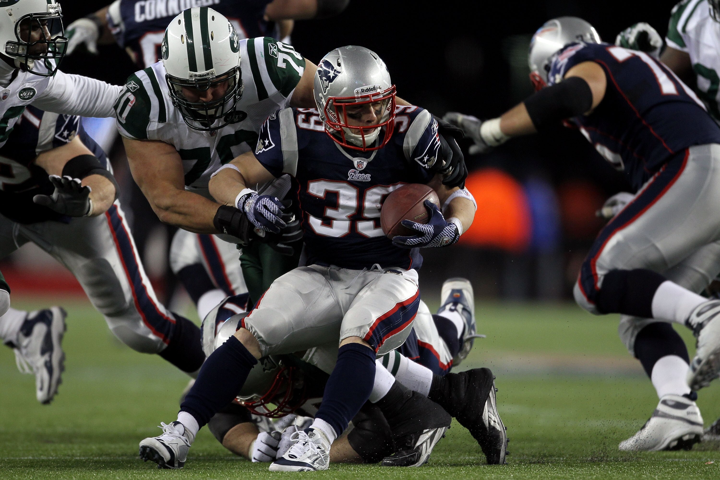 FOXBORO, MA - JANUARY 16:  Mike DeVito #70 of the New York Jets tackles Danny Woodhead #39 of the New England Patriots during their 2011 AFC divisional playoff game at Gillette Stadium on January 16, 2011 in Foxboro, Massachusetts.  (Photo by Jim Rogash/G