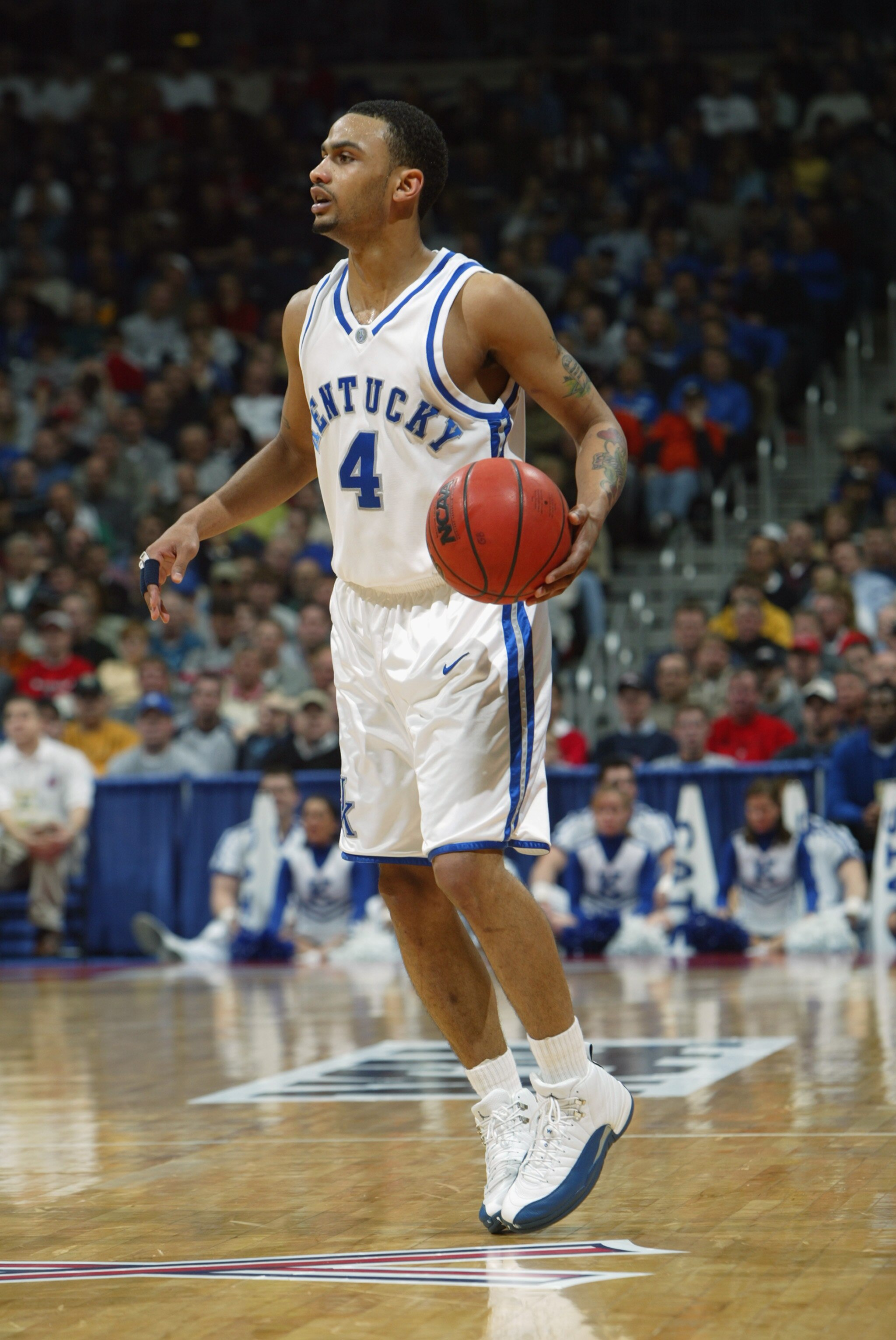 COLUMBUS, OH - MARCH 21:  Gerald Fitch #4 of the Kentucky Wildcats moves the ball during a second round game of the NCAA Division I Men's Basketball Tournament against the UAB Blazers at Nationwide Arena on March 21, 2004 in Columbus, Ohio. UAB defeated K