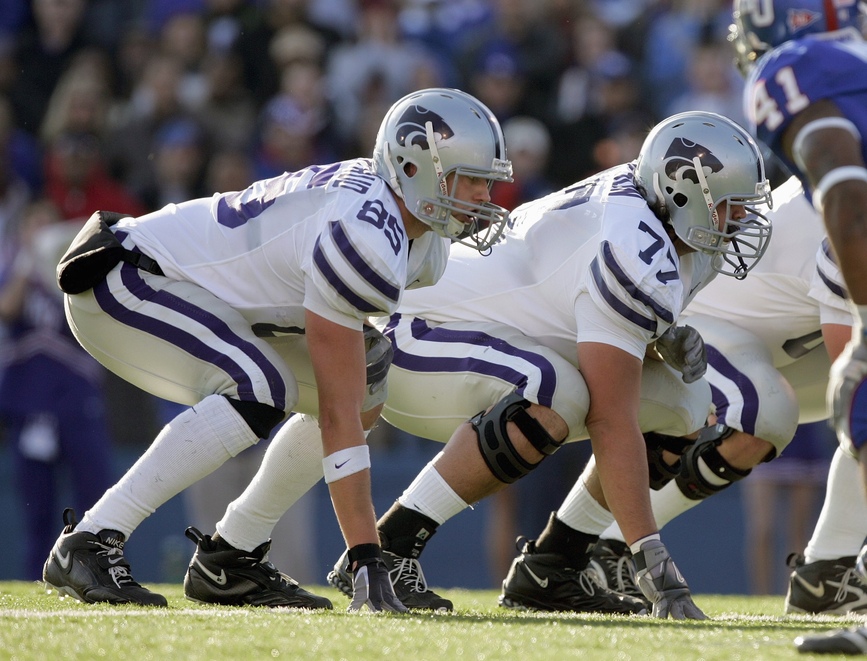 LAWRENCE, KS - NOVEMBER 18: Jeron Mastrud #85 and Michael Frieson # 77 of the Kansas State Wildcats gets ready on the line of scrimmage during the game against the Kansas Jayhawks on November 18, 2006 at Memorial Stadium in Lawrence, Kansas.  Kansas won 3