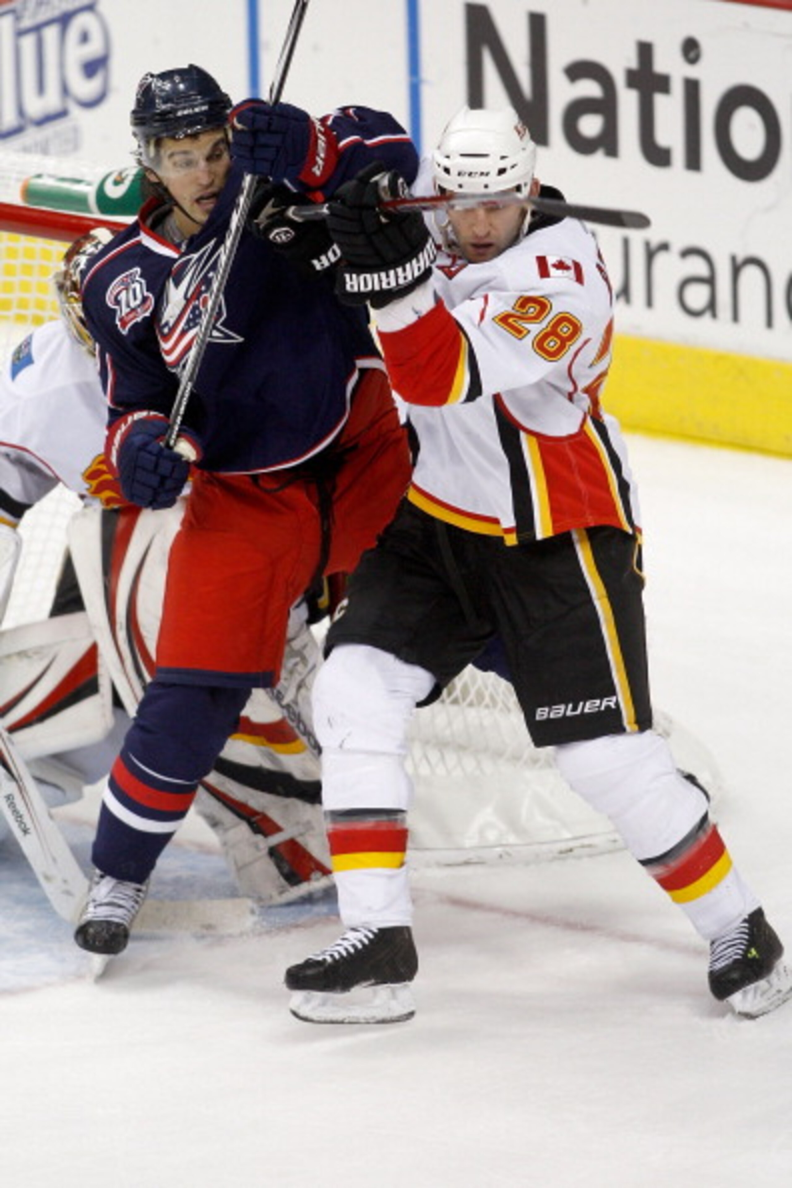 COLUMBUS, OH - DECEMBER 21:  Robyn Regehr #28 of the Calgary Flames and Antoine Vermette #50 of the Columbus Blue Jackets battle for position in front of goaltender Henrik Karlsson #35 of the Calgary Flames during the third period on December 21, 2010 at